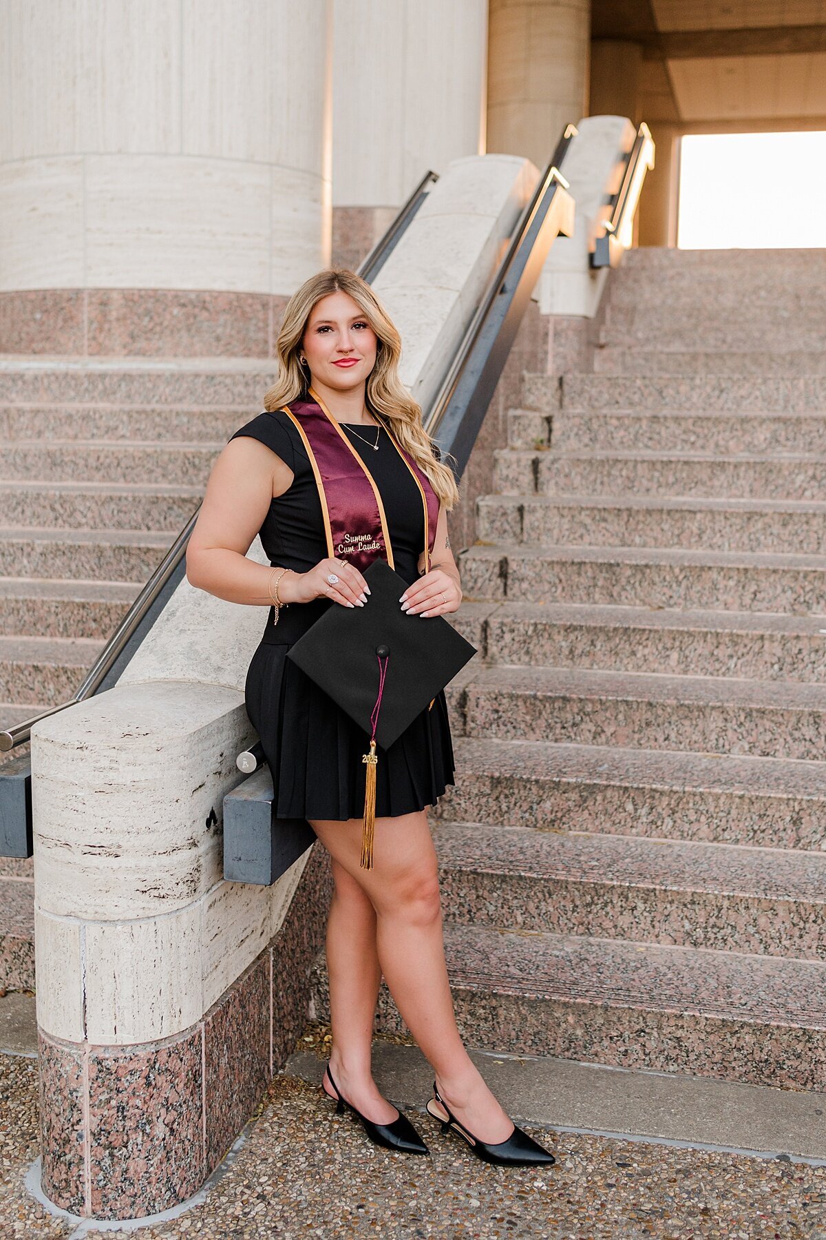 Texas state grad posing at alkek