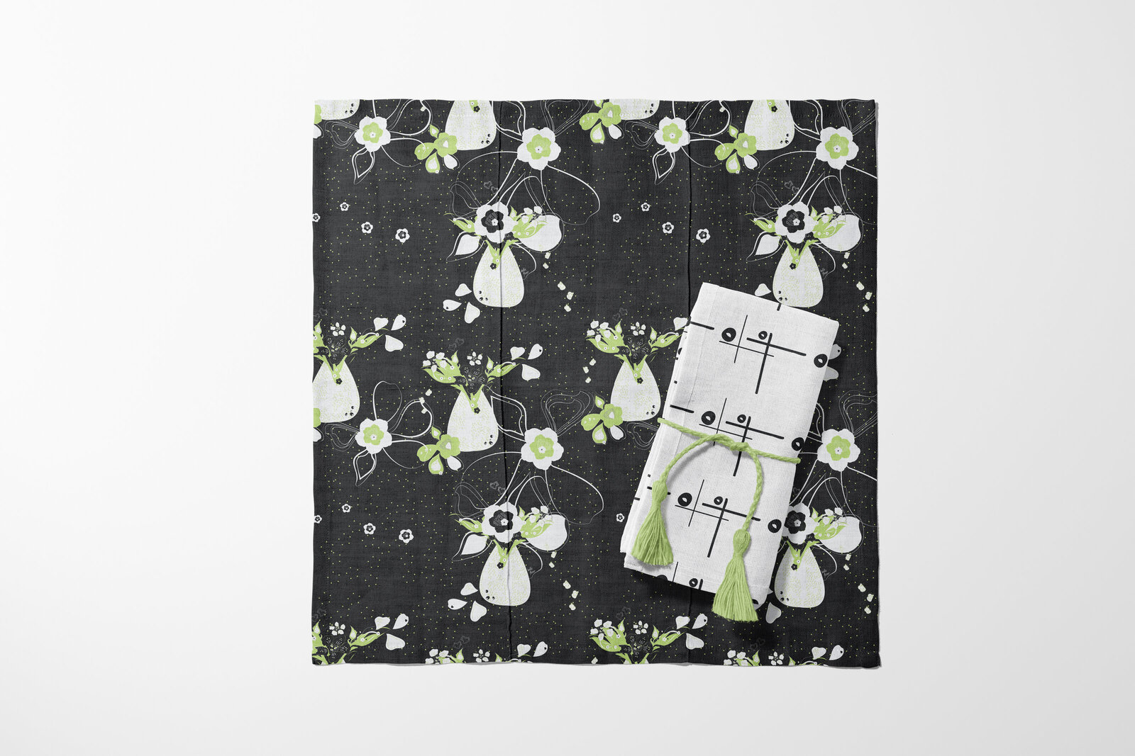 black, white, and green fabric placemat and napkin