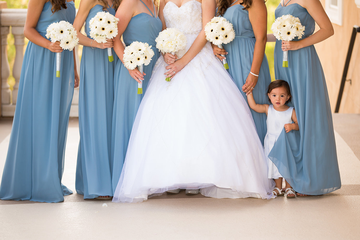 bridesmaids with blue dressed and white flowers