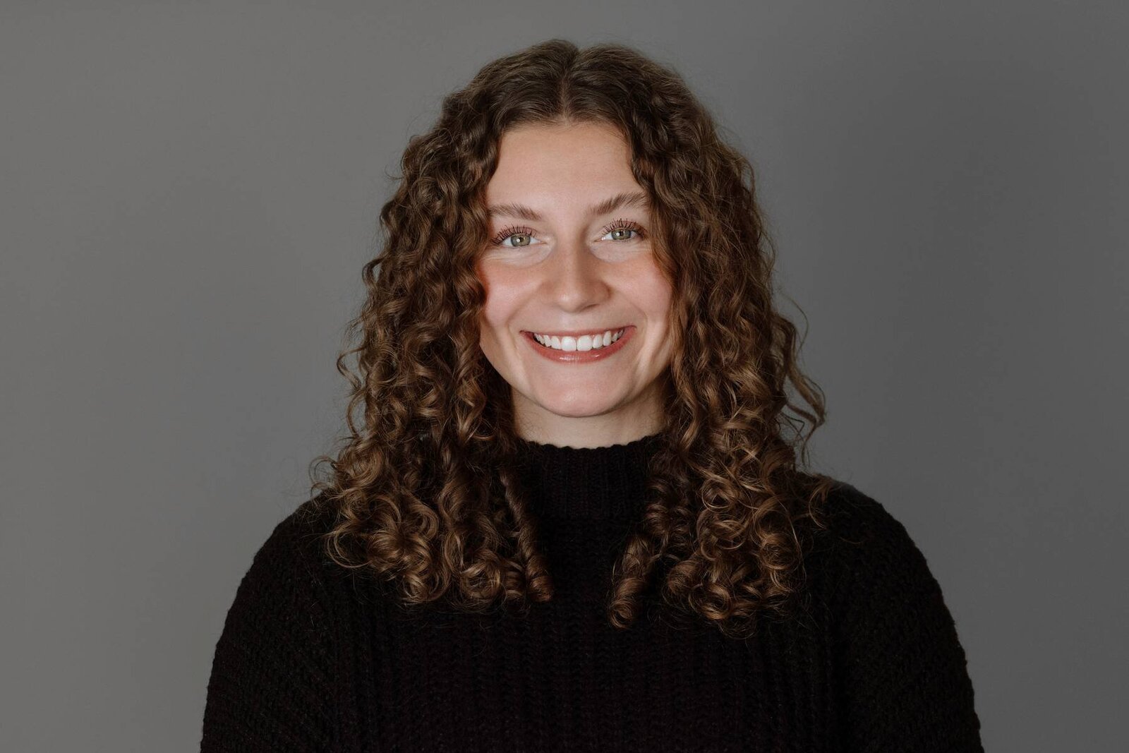 Executive studio portrait of a woman, projecting leadership and sophistication in a professional setting