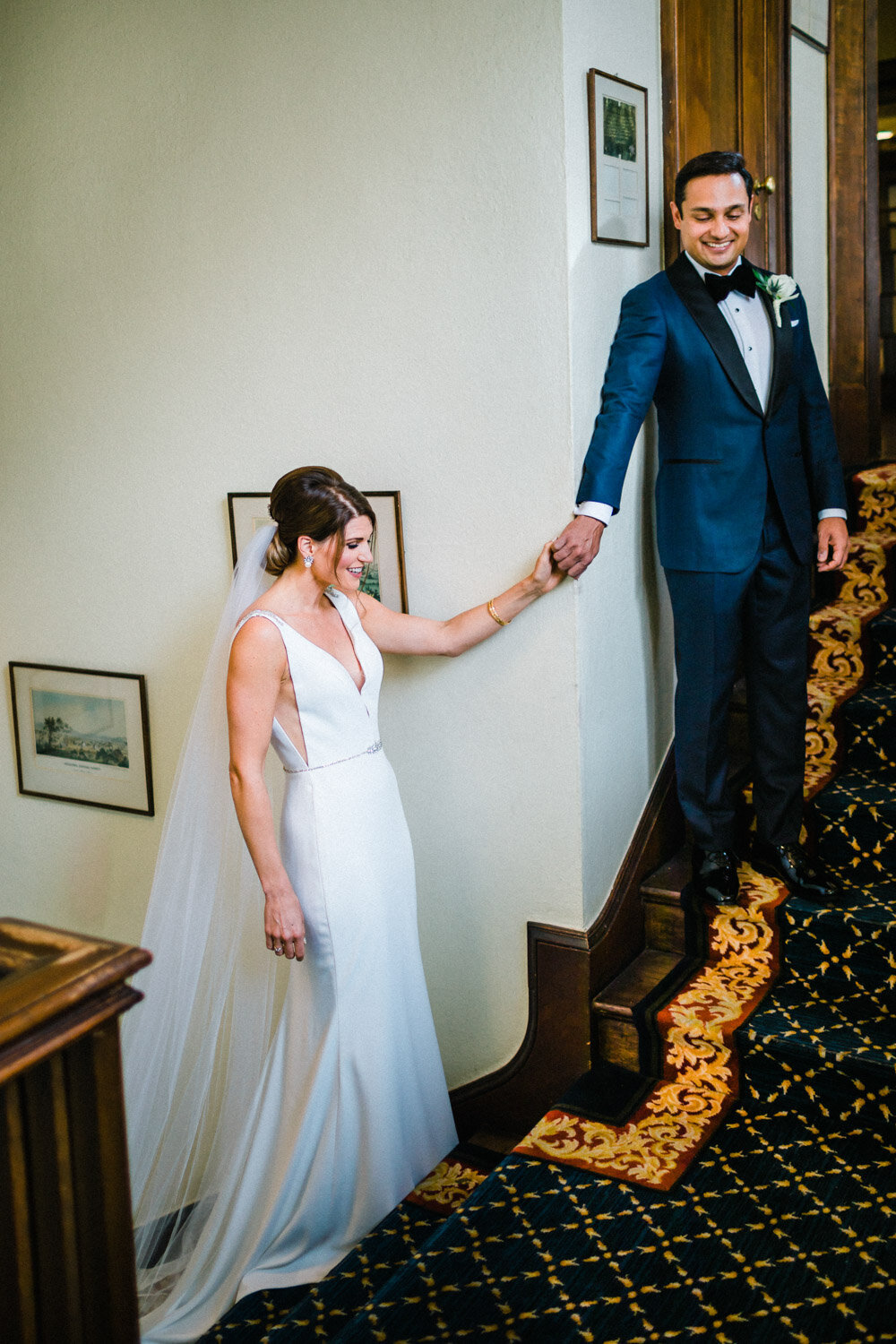 Bride and groom holding hands during first look