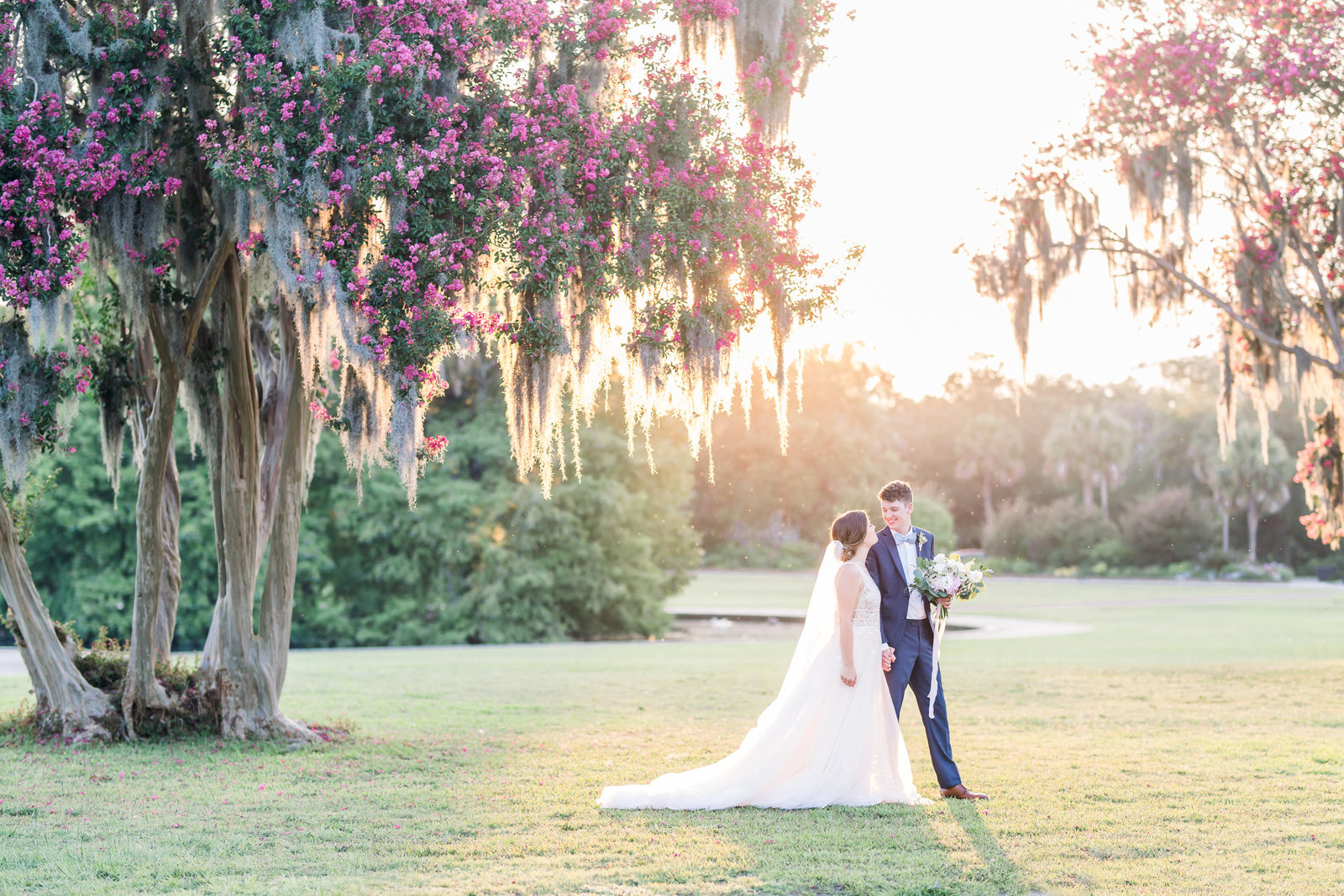 Newlywed couple walk in garden of Legare Waring House, South Carolina.