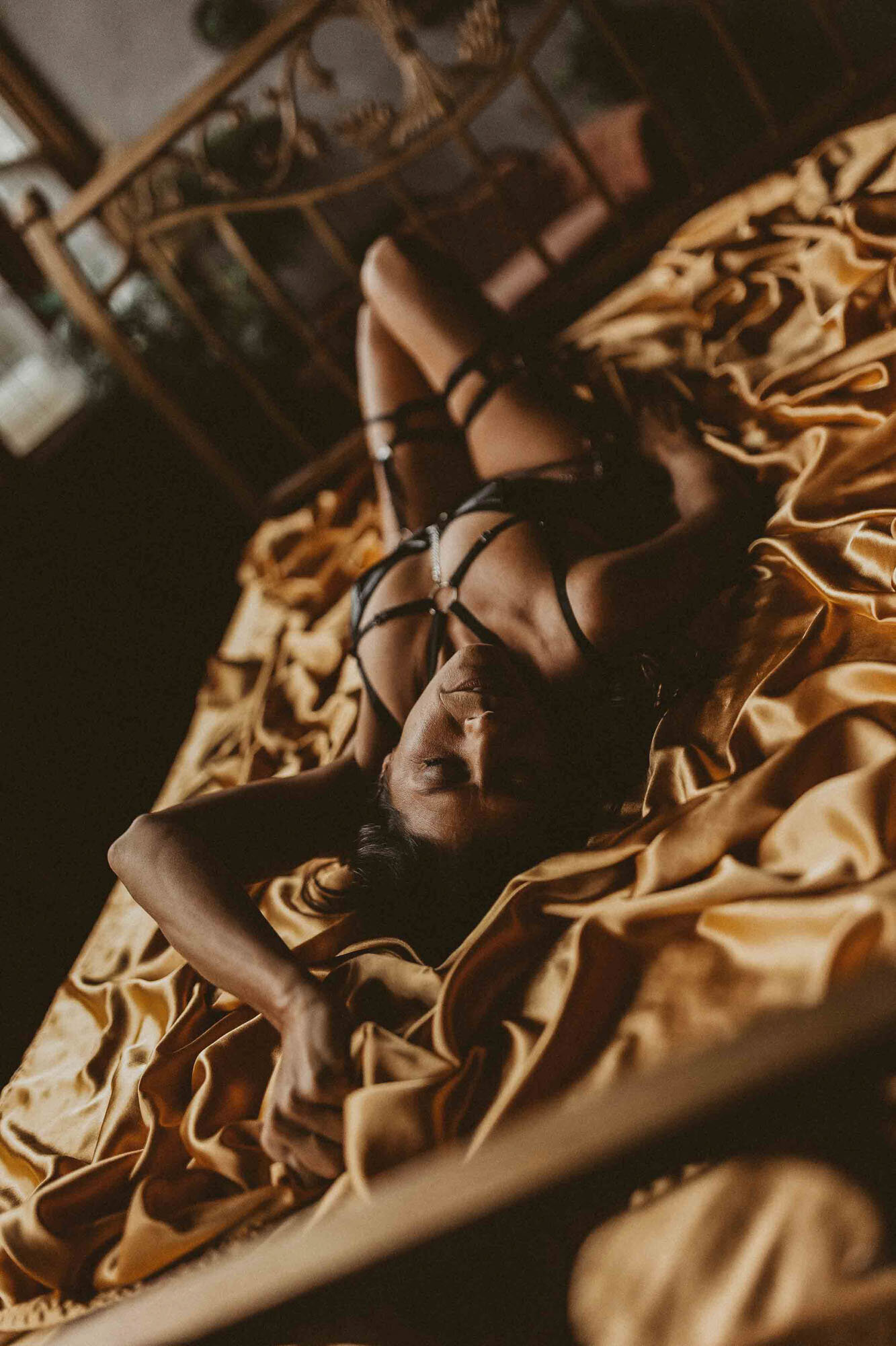 photo of a woman laying in bed in stories untold studio