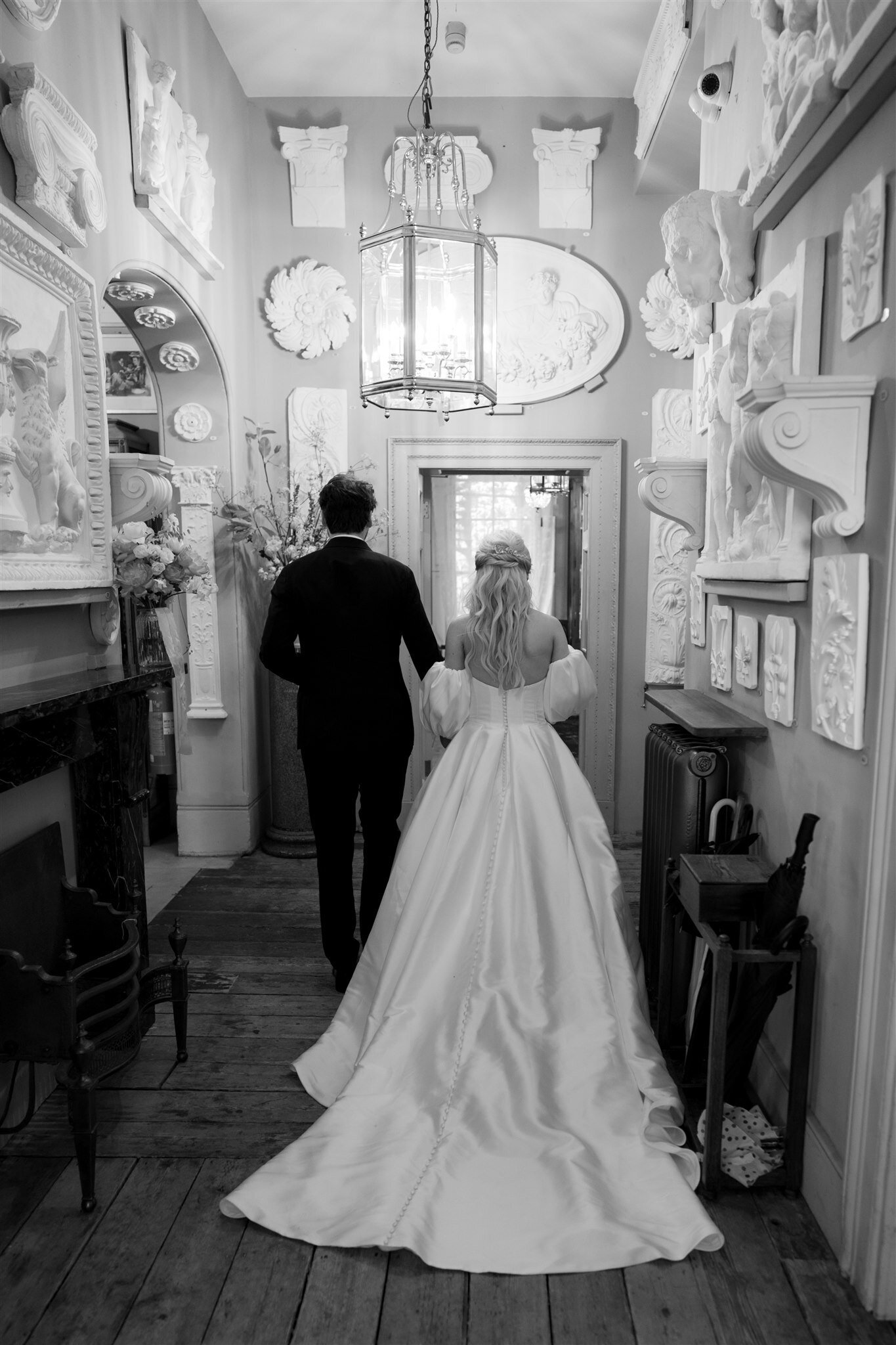 bride and groom walking into brunswick house for their wedding reception in london