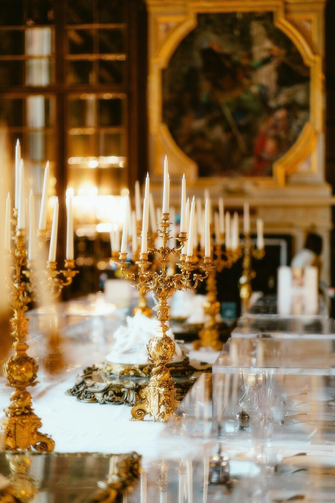 Luxurious table setting with ornate gold candelabras and elegant decor