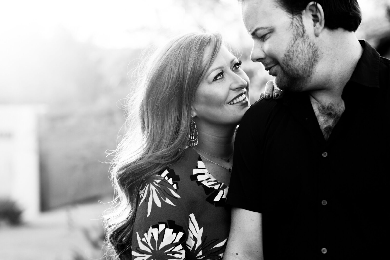 engagement session with couple looking at each other