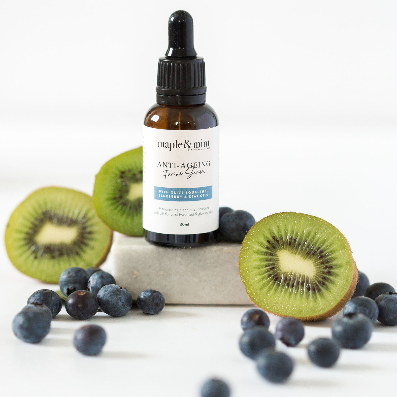 Small business branding product skincare photographer featuring natural ingredients of kiwi and blueberries for styled product photography by Chelsea Loren.