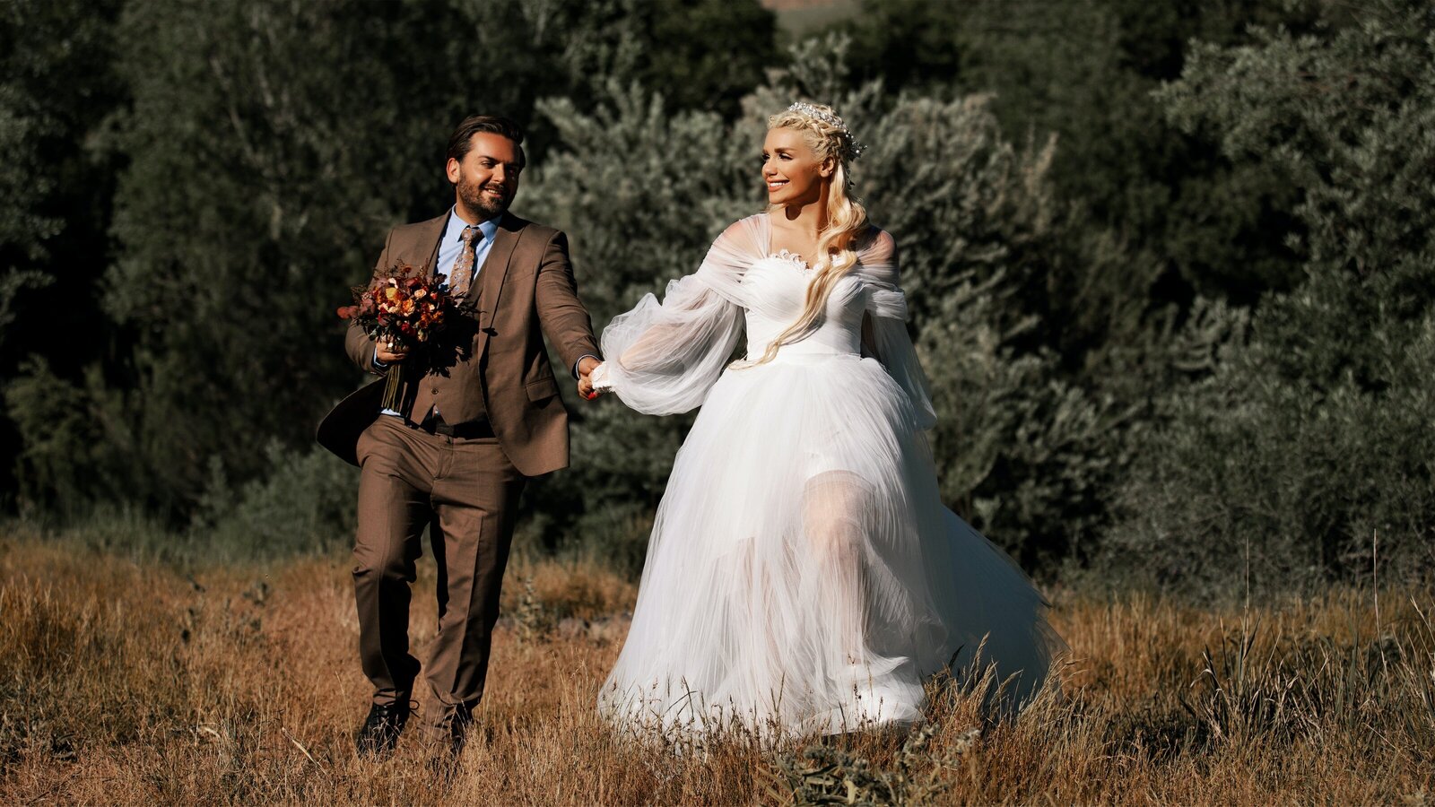 bride-and-groom-walking-in-field-2907680