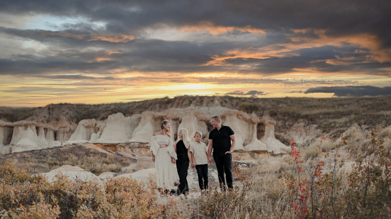 A family of four enjoys each other's company at the Colorado paint mines at sunset during the fall.