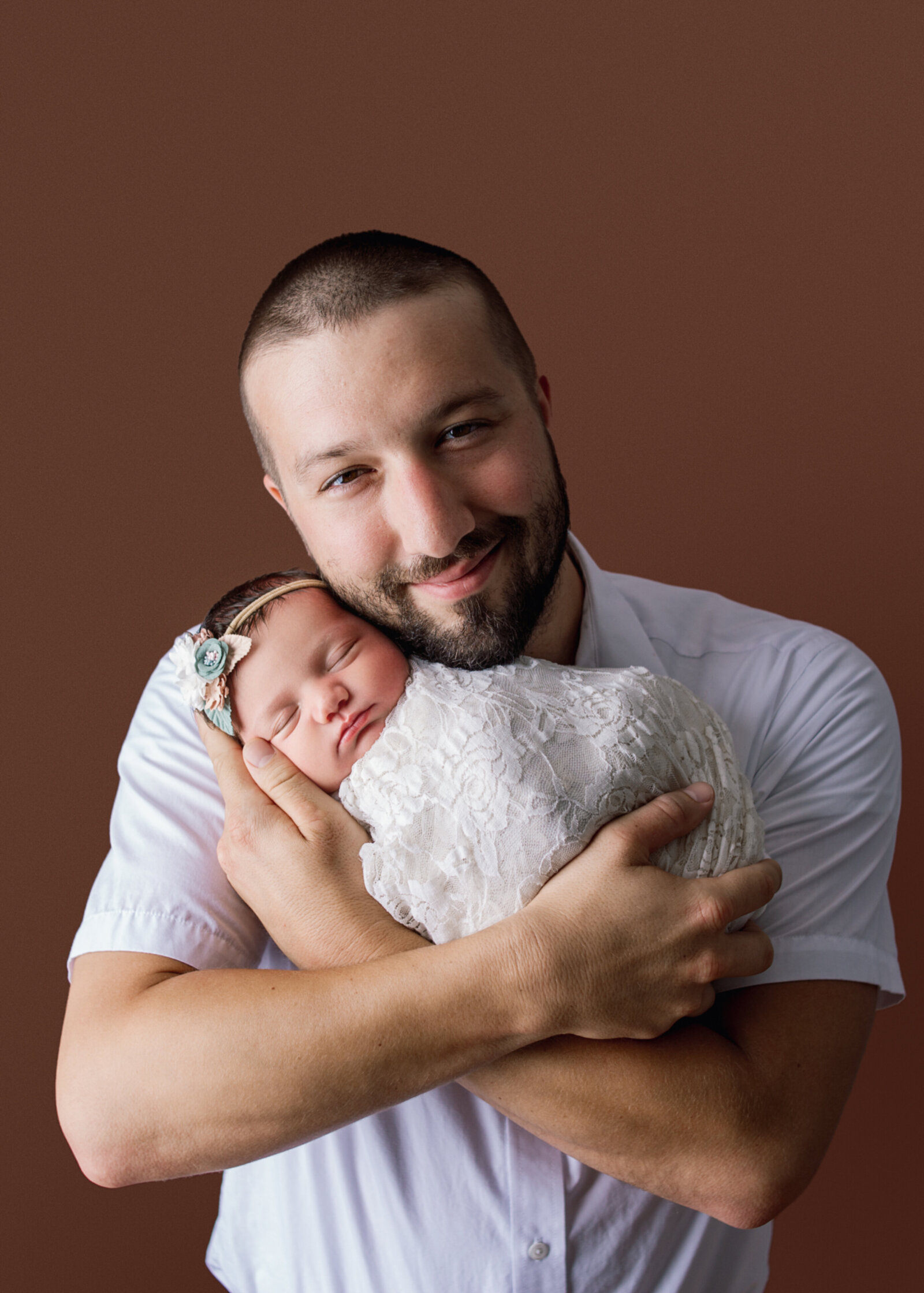 Dad holding baby girl wrapped in lace with white shirt during newborn photoshoot with Nashville TN photographer