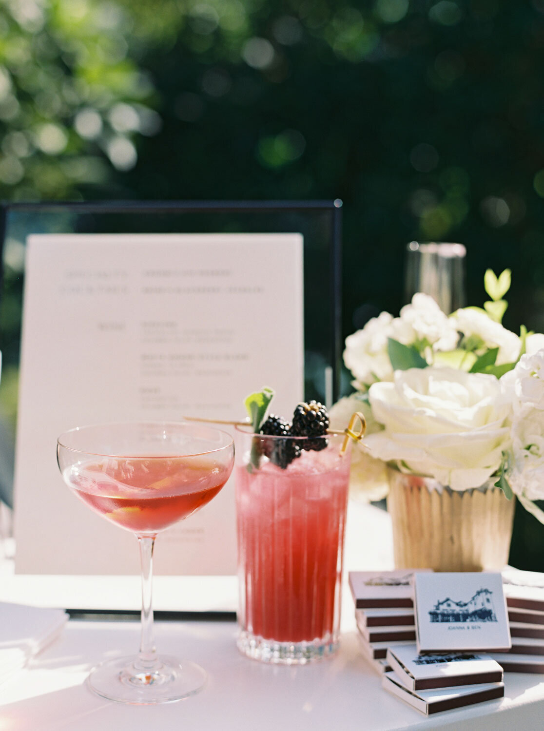 Signature cocktails displayed with floral decor