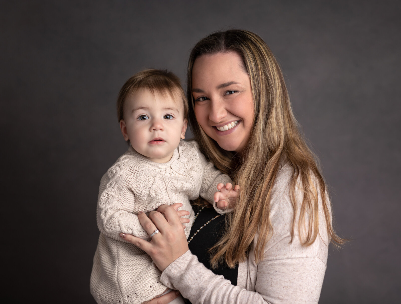 mother holding daughter for studio portraits cleveland family photography
