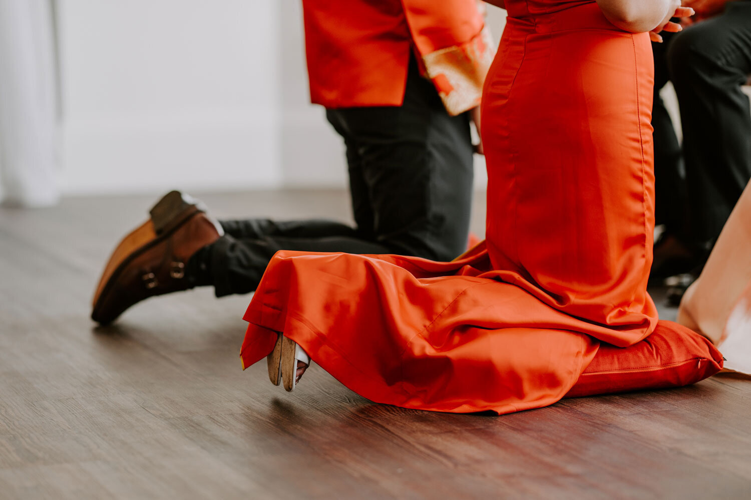 Traditional wedding tea ceremony with the couple kneeling before elders