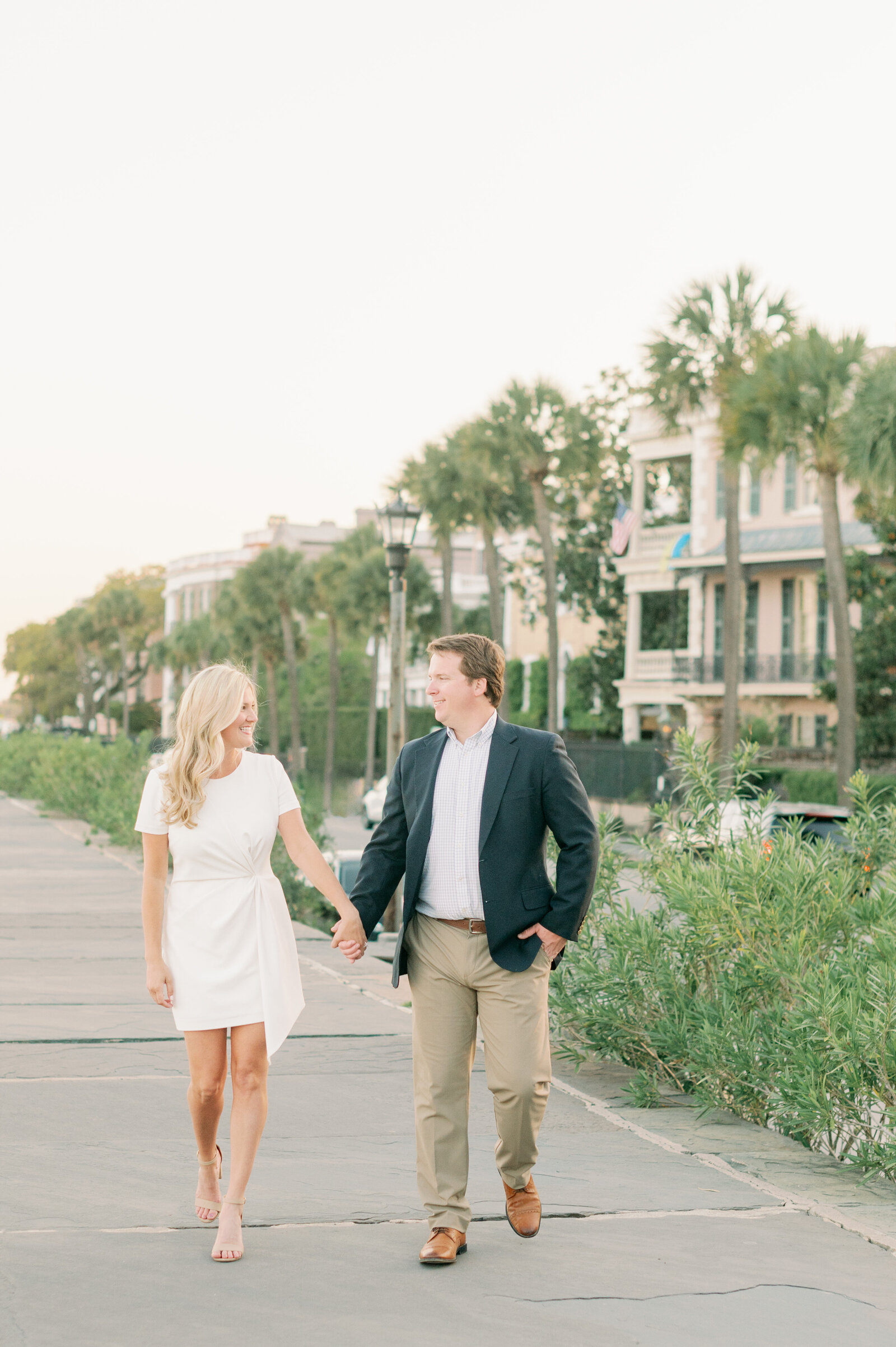 Couple walks, holding hands at the Battery in Charleston South Carolina