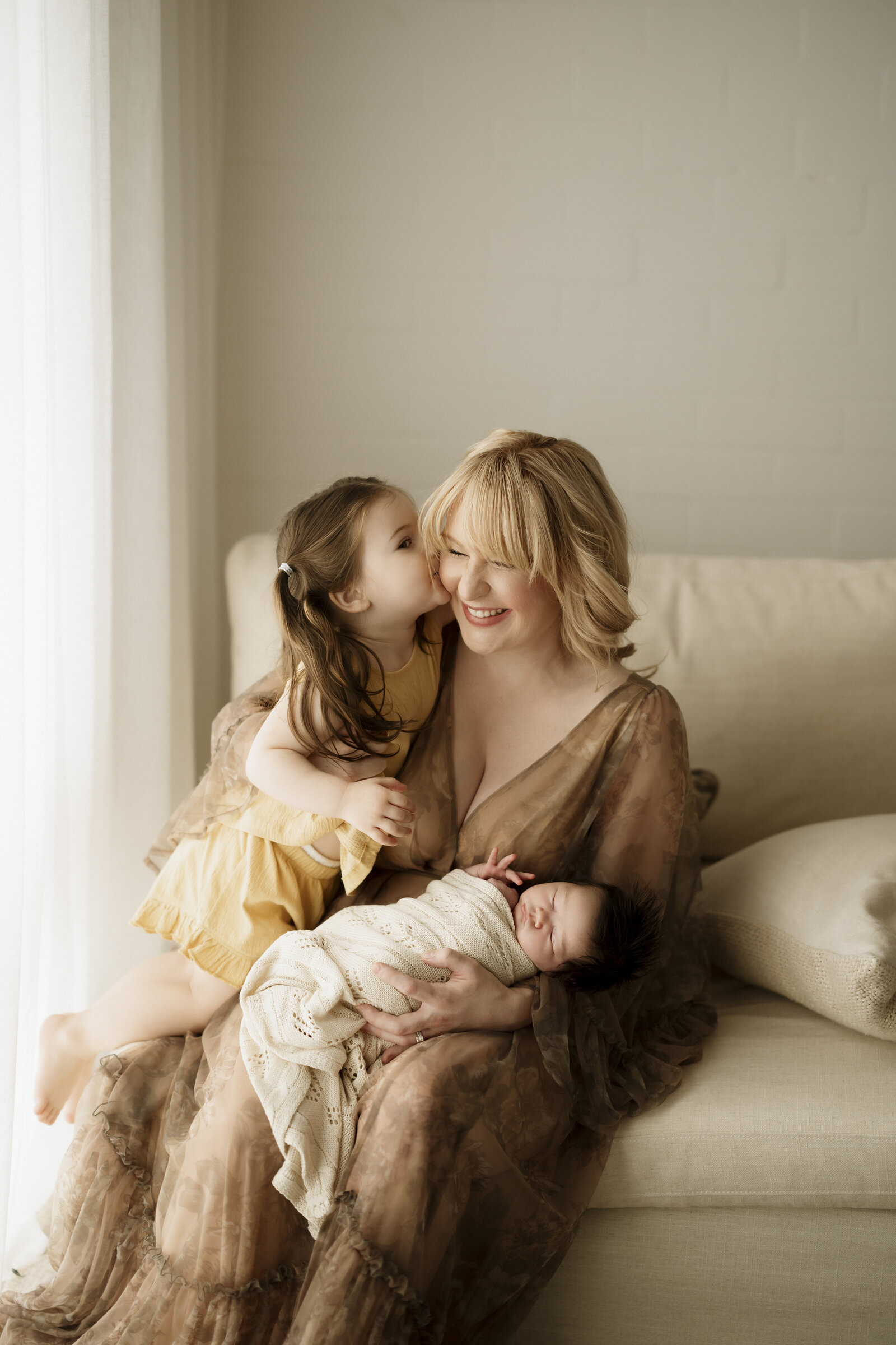 Natural newborn family portraits in a Perth studio – soft, warm, and organic images capturing the love of a growing family.