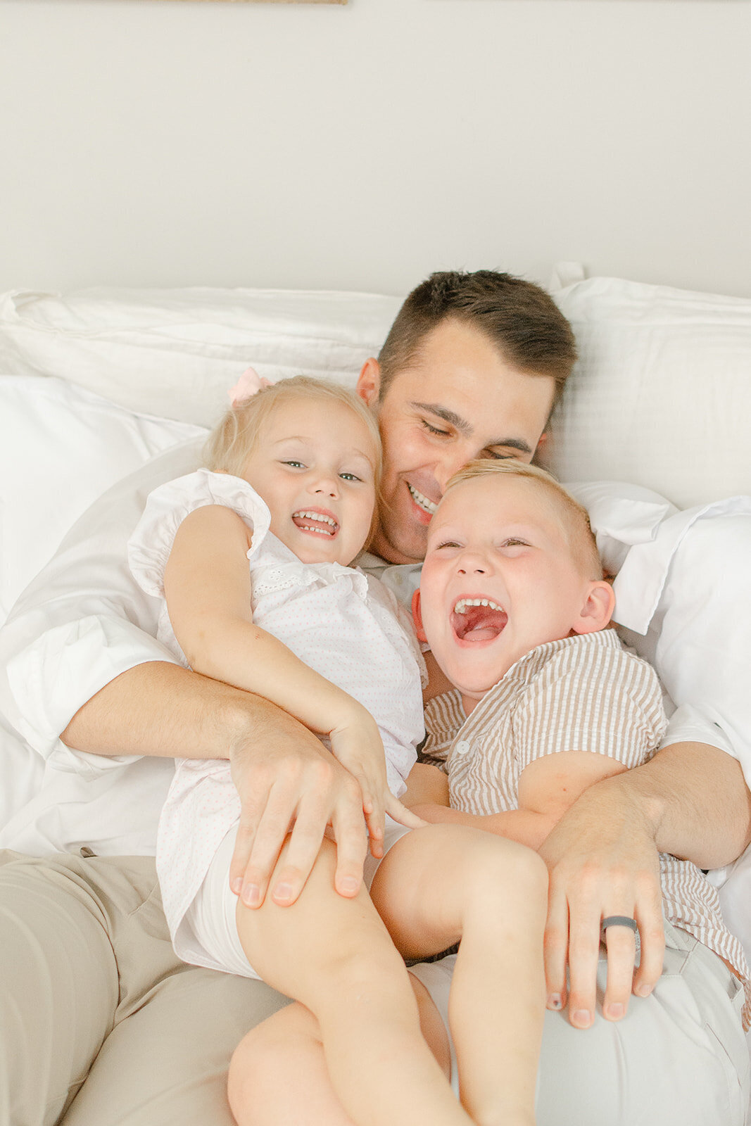 dad and kids having a tickle fight during DMV newborn picture