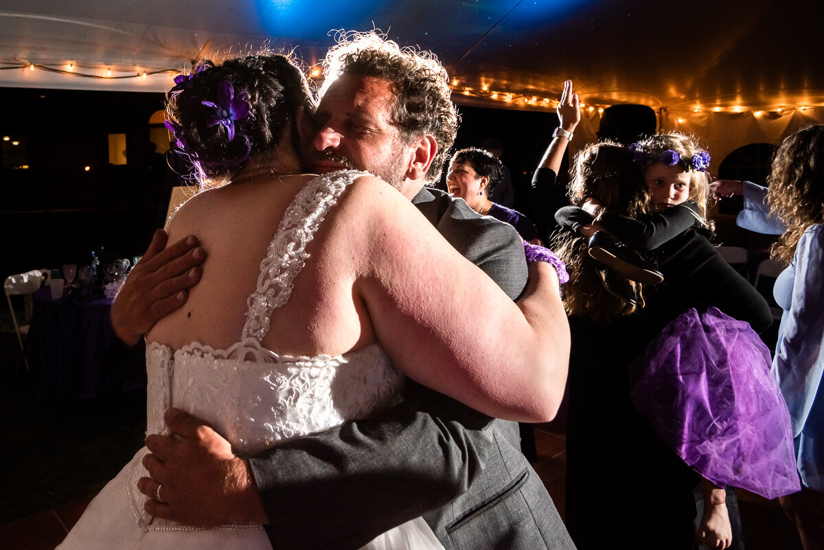 bride hugging guest on dancefloor