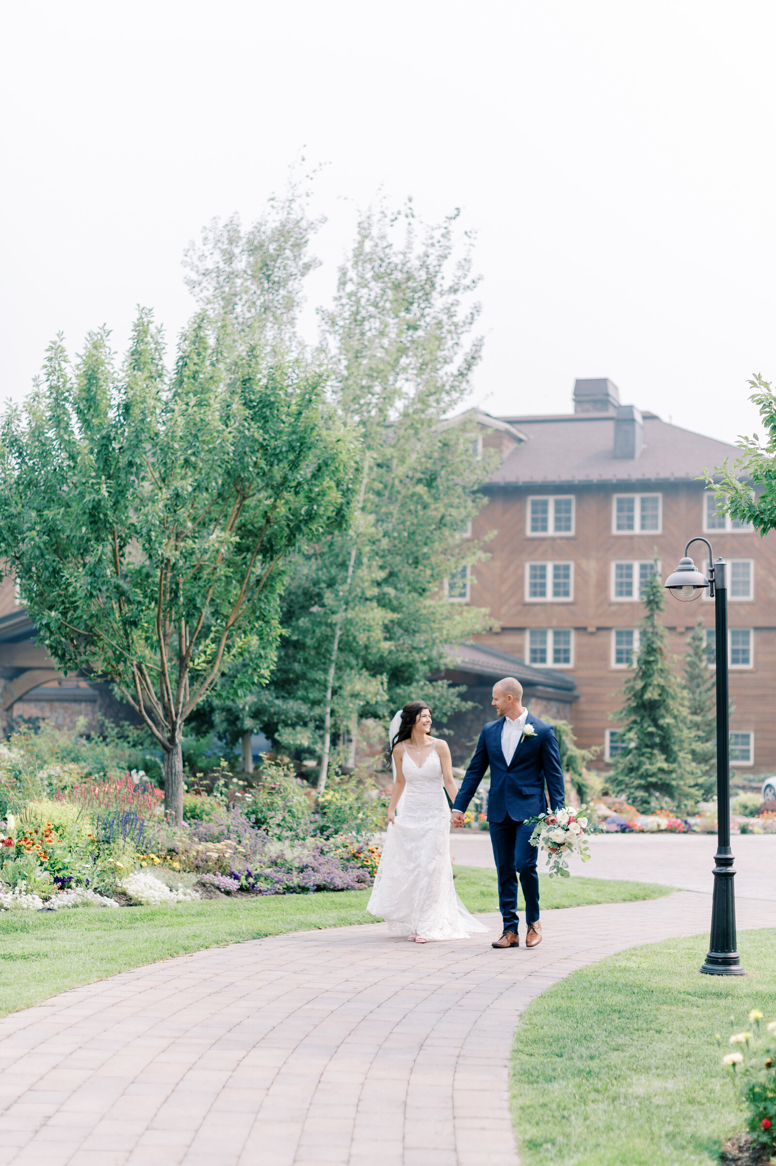 Bride and groom walking in front of the Sun Valley Resort at Trail Creek Cabin Wedding taken by the Best Sun Valley Wedding Photographers