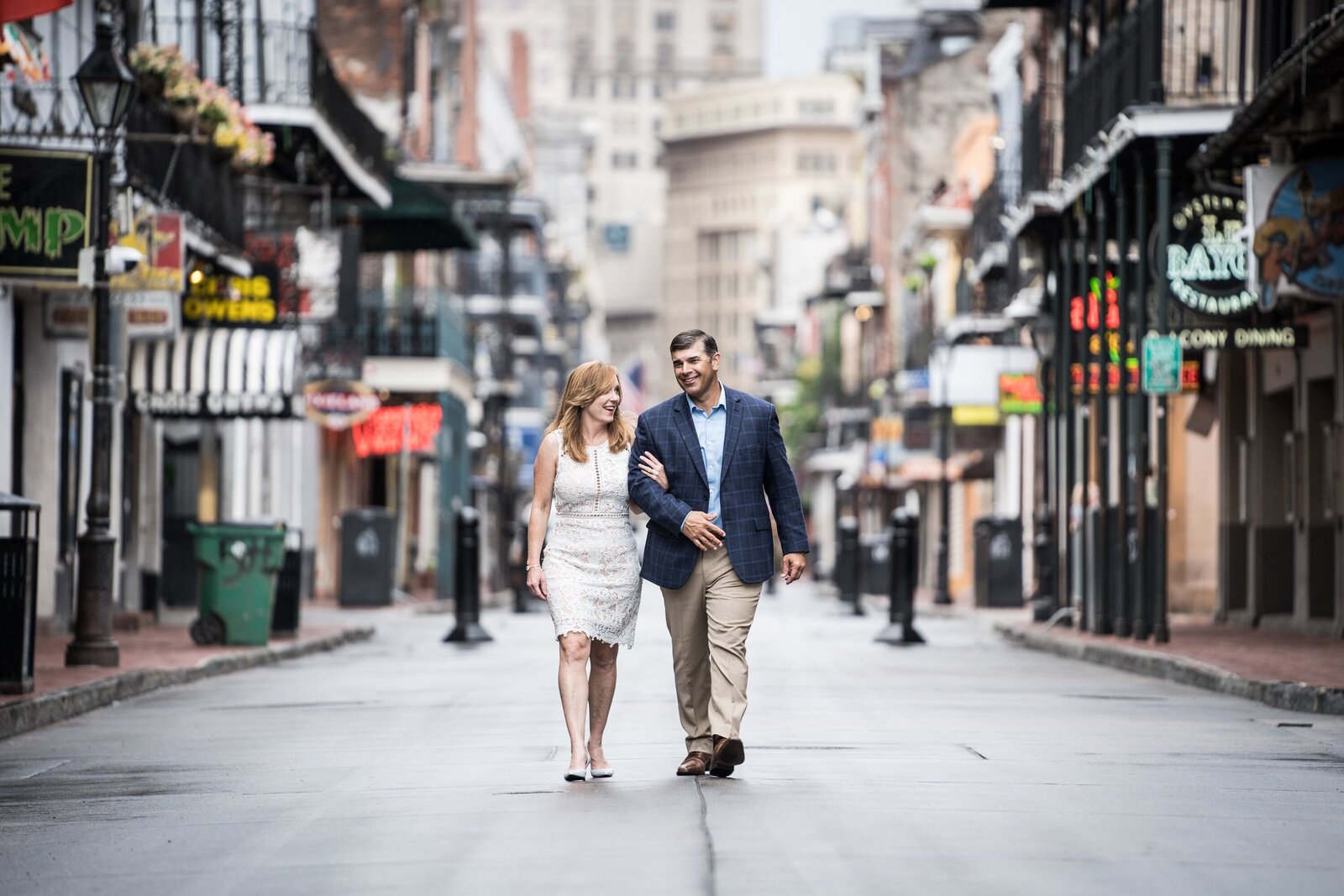 Couple walking on an empty Bourbon Street during COVID