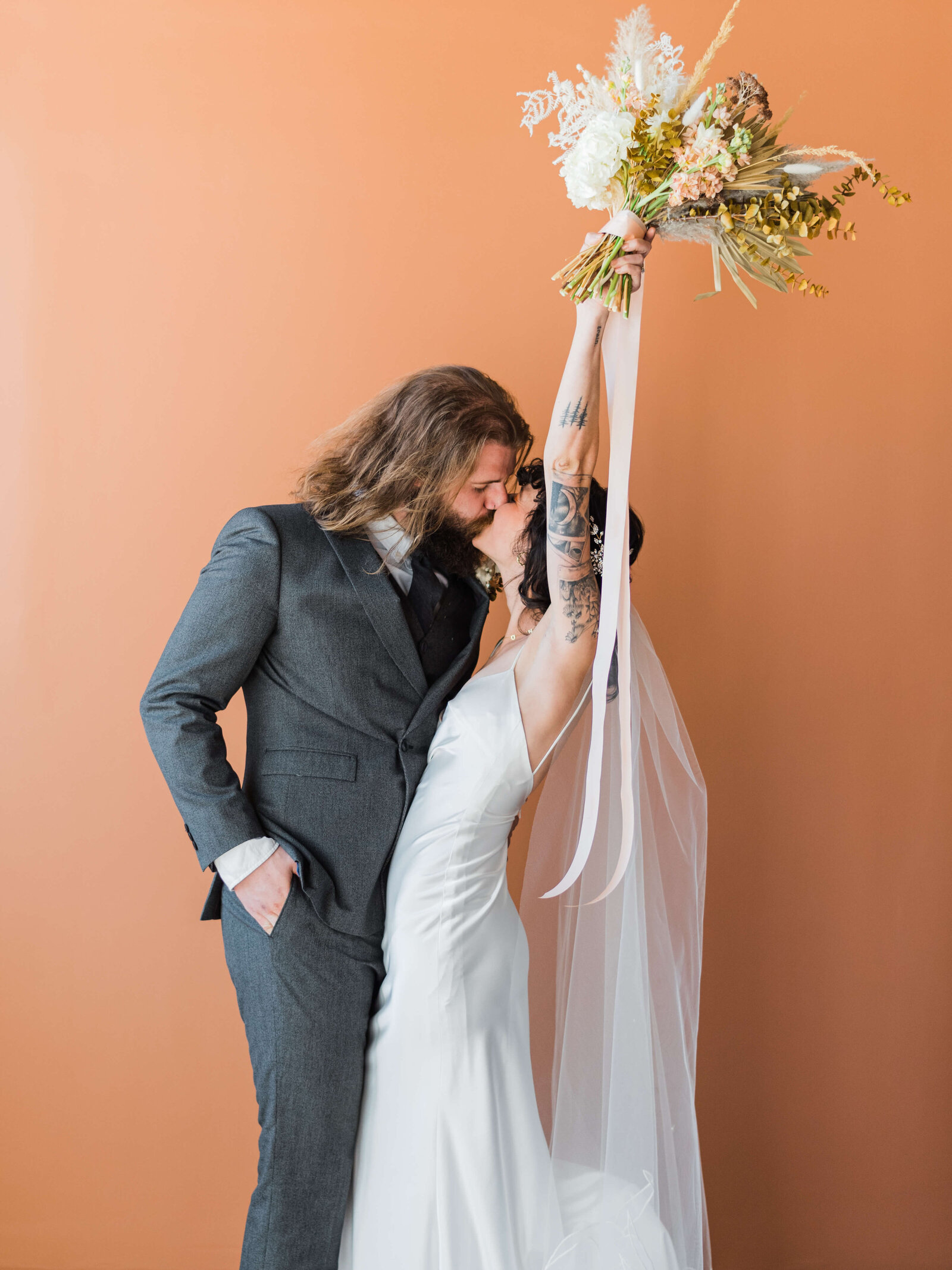 Husband and wife kiss and celebrate after getting married in a ceremony captured by Virginia Wedding Photographer