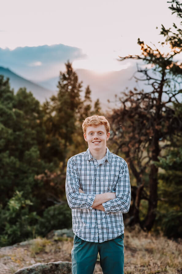 Boy crosses arms and smiles for photos at Mt. Falcon park.
