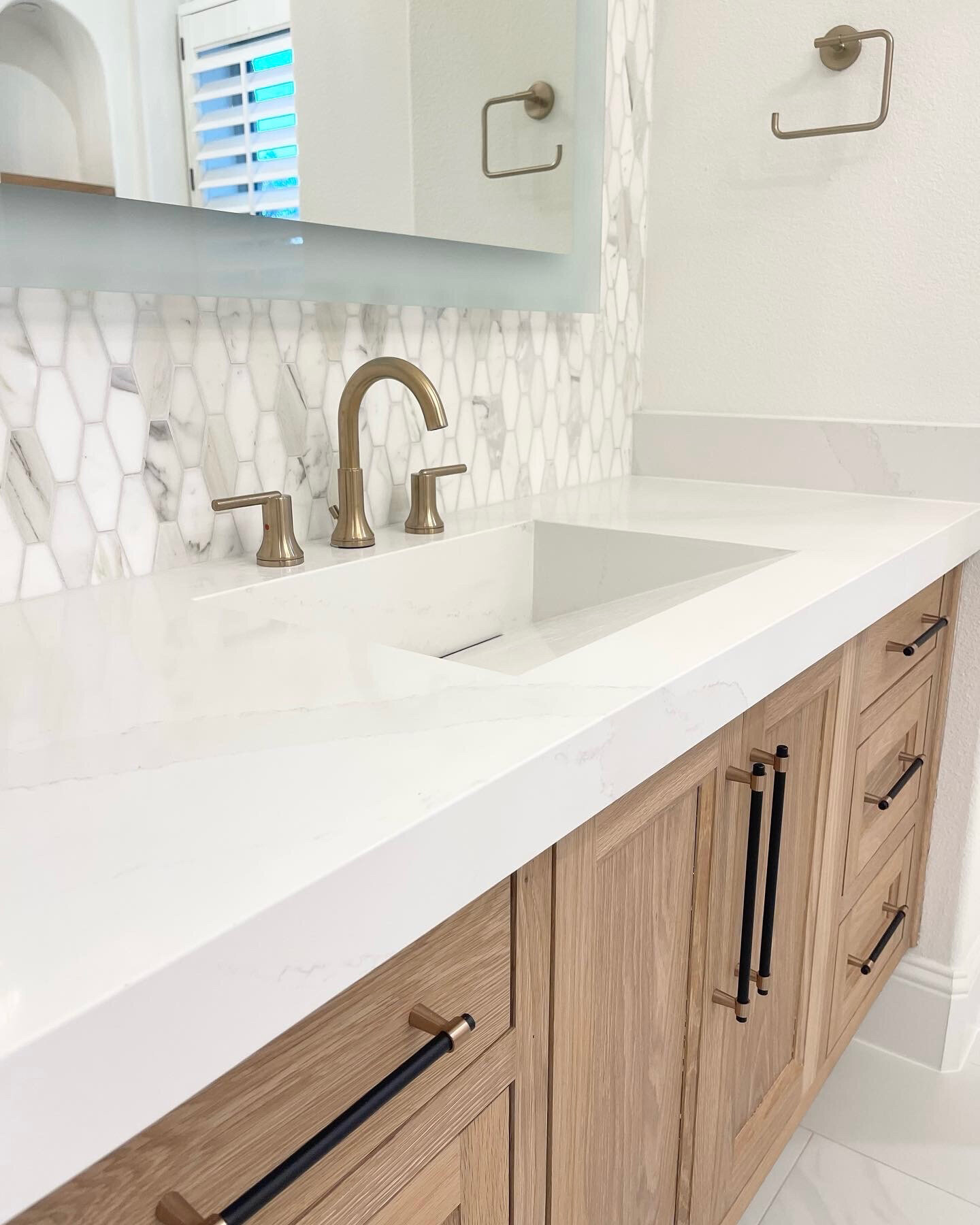 Custom home renovation design for a white elegant bathroom, featuring sleek fixtures, a modern vanity, and luxurious finishes that create a serene and sophisticated atmosphere.