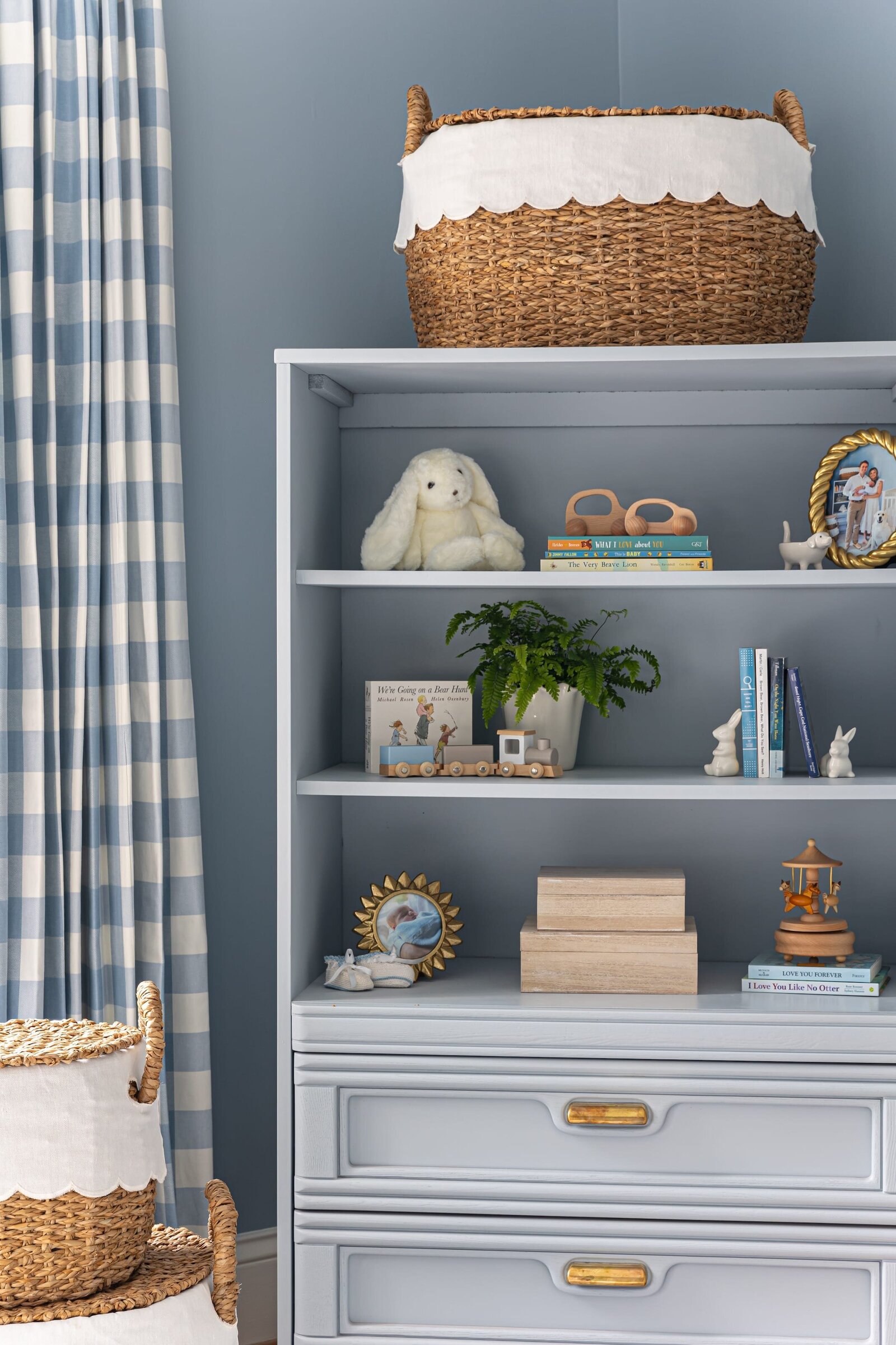 melinda chesson interiors bay street nursery with blue bookcase with styled shelves