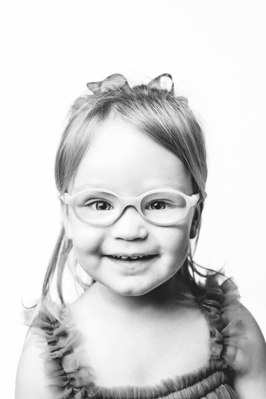 Young girl with luminescent eyes smiling sweetly at Tampa photographer