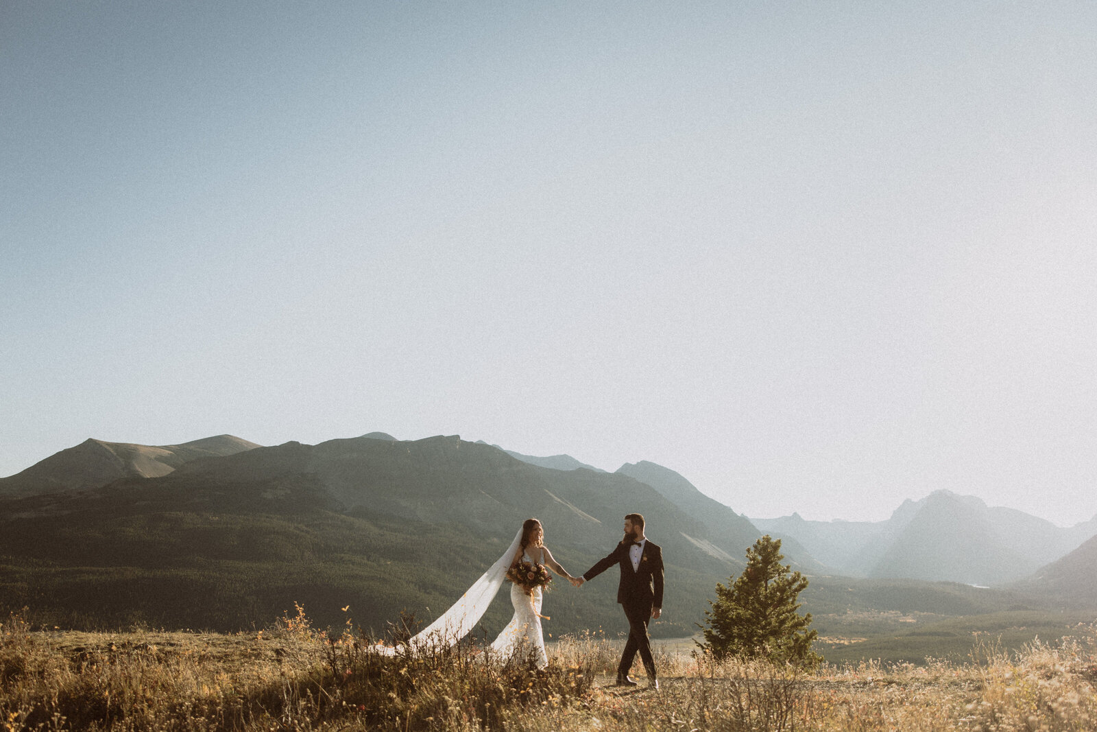 couple walking holding hands during their outdoor elopement in montana