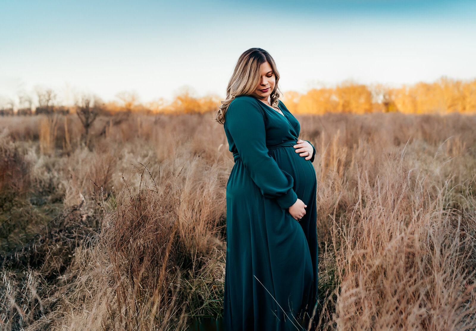 pregnant mom standing in a field