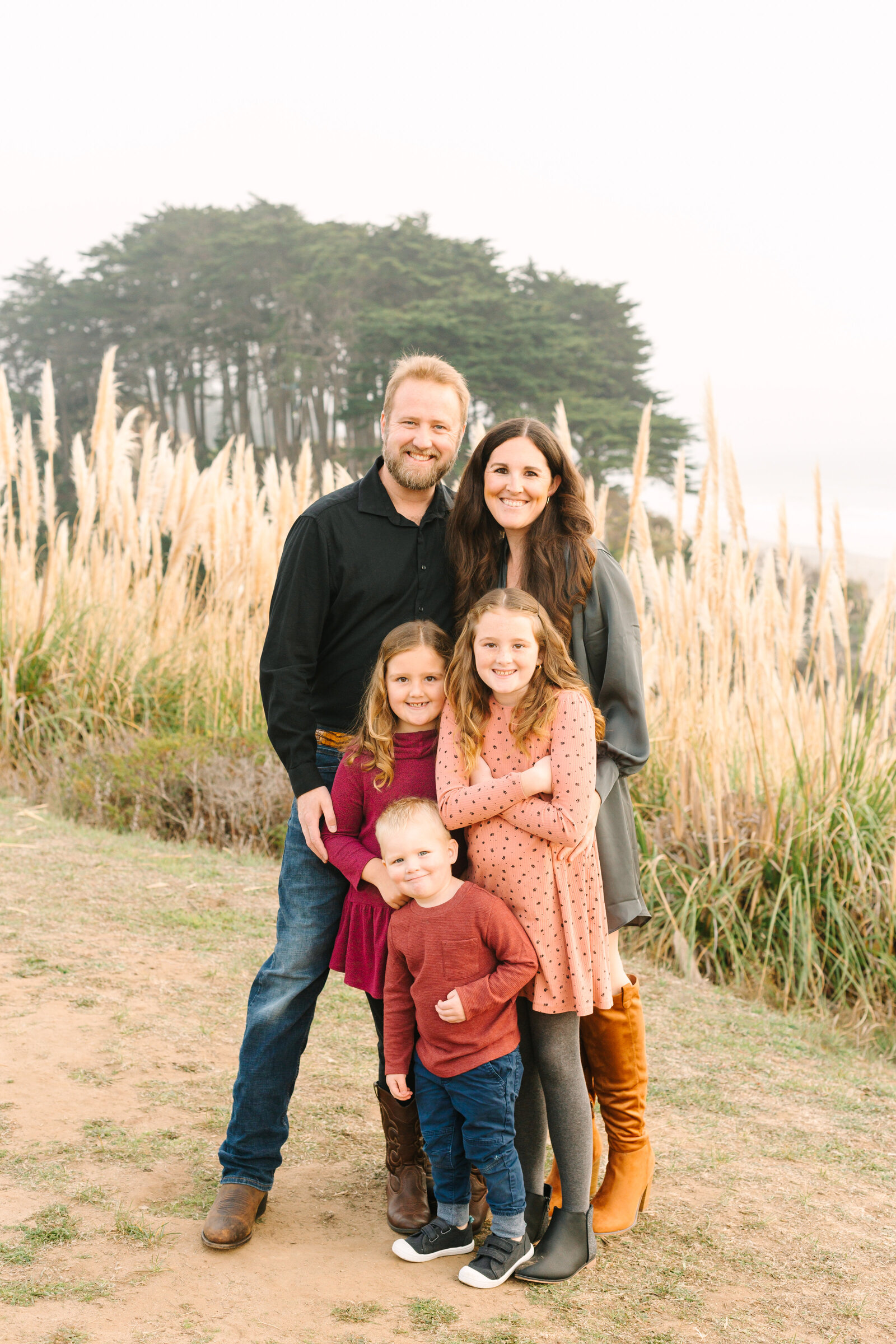 A family poses for photos along the beach in Santa Cruz, Ca.