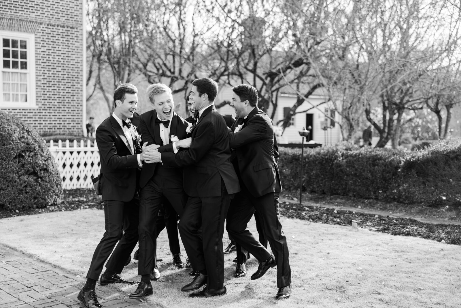 Groom and groomsmen pose in a mix of formal and playful moments at Inola in Blue Ridge, GA, celebrating friendship and camaraderie on the wedding day.