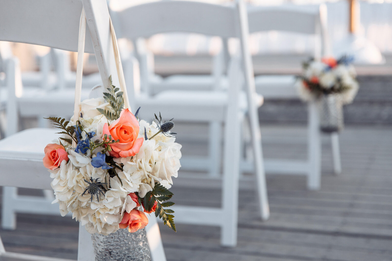 Wedding ceremony chairs for guests with florals
