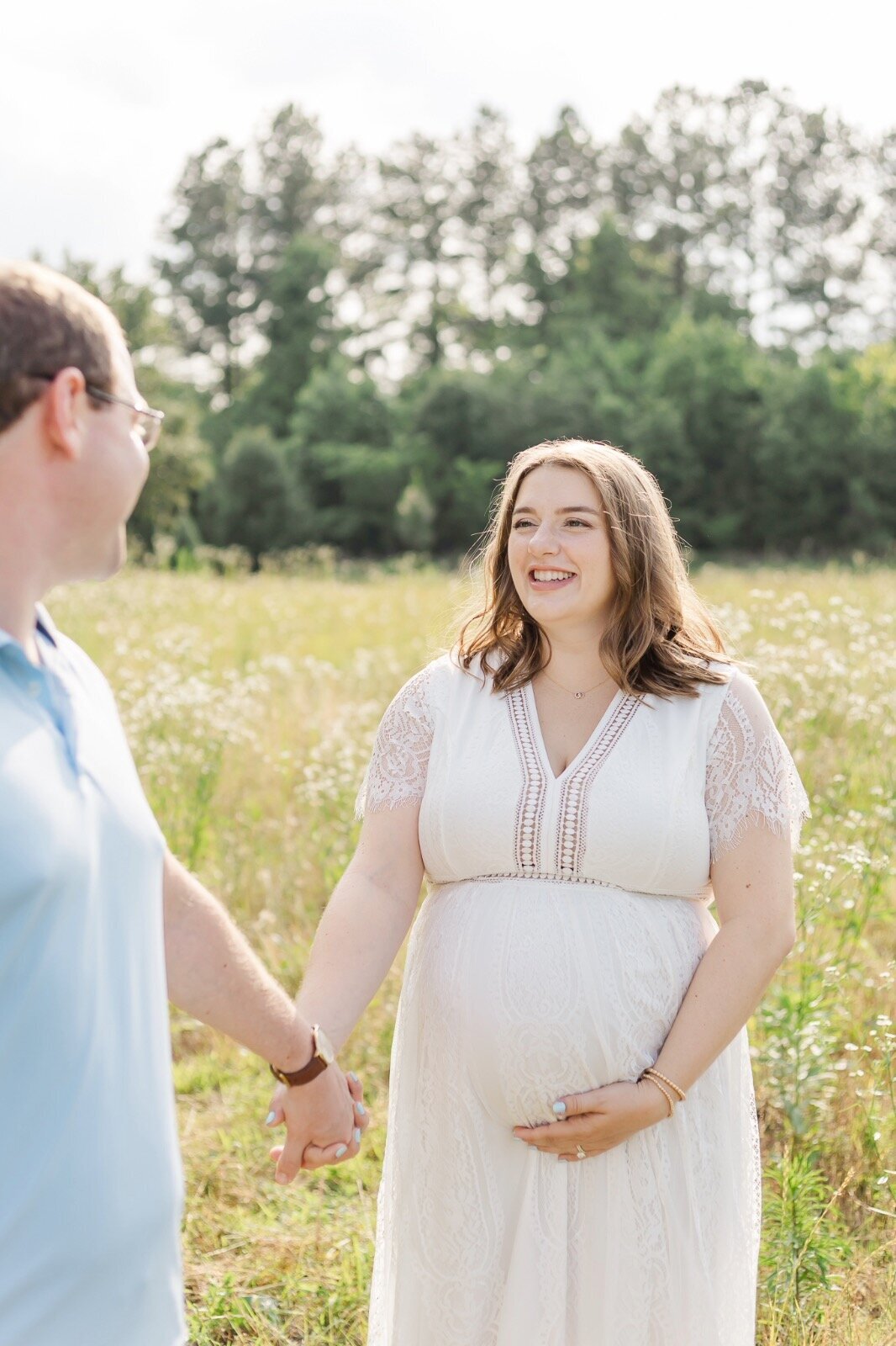 Husband looking back at pregnant wife smiling