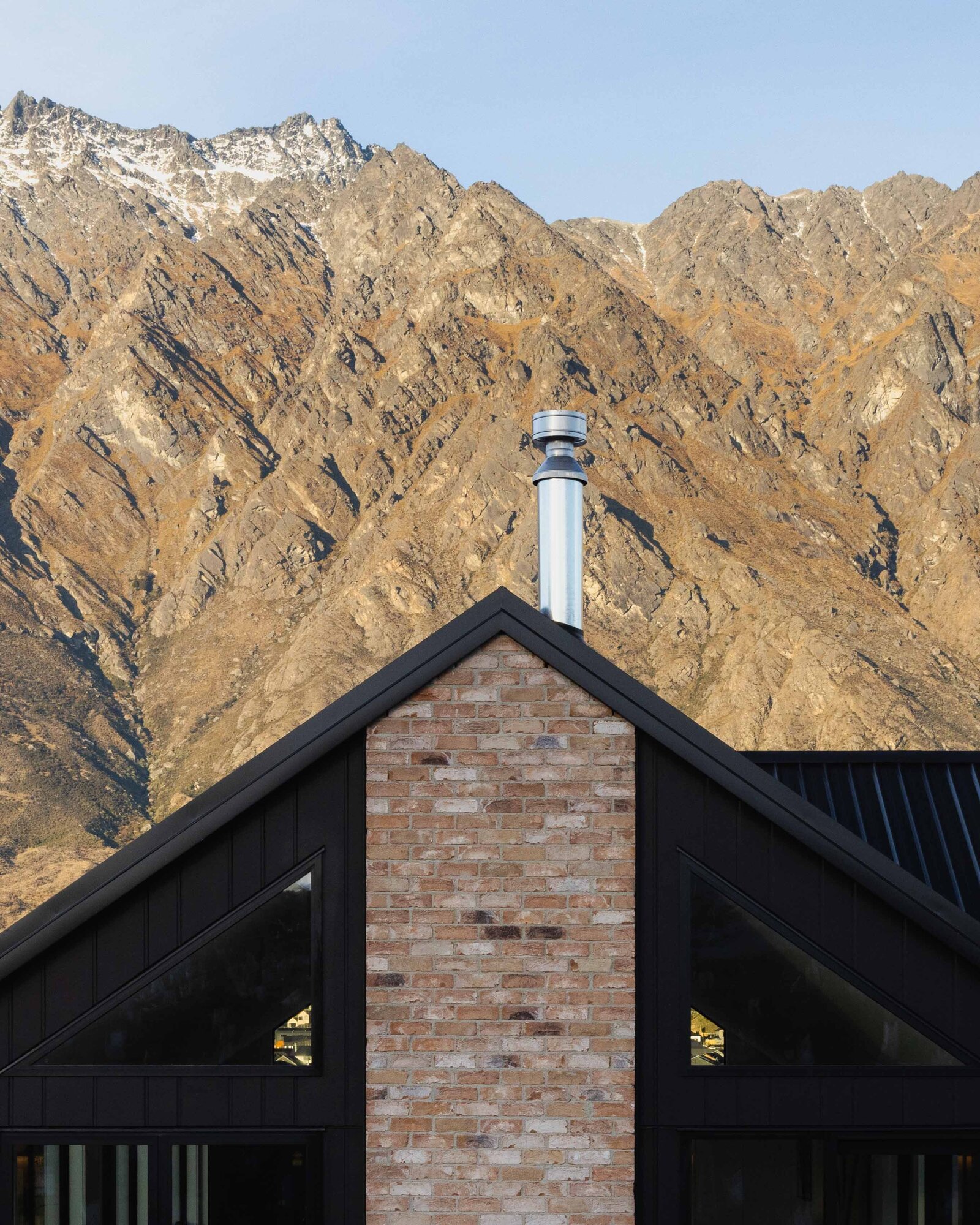 A brick chimney and James Hardy Oblique exterior of a home built by Twin Peaks Construction in Hanleys Farm, Queenstown.