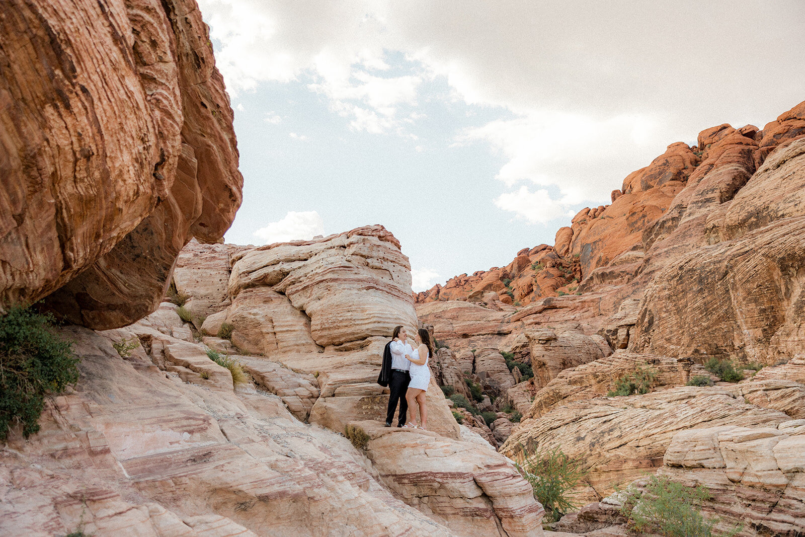 Couple who just got engaged posing at The Red Rock Valley in Nevada
