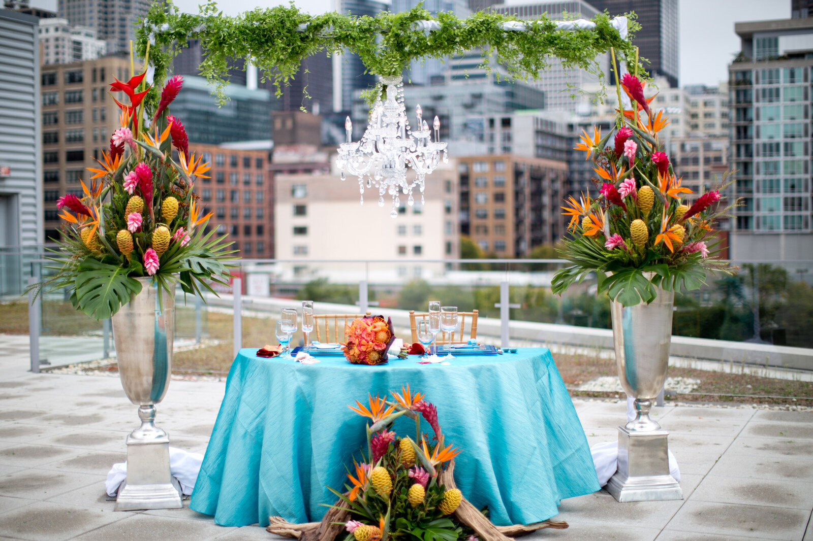 Wedding reception round table with floral arch backdrop