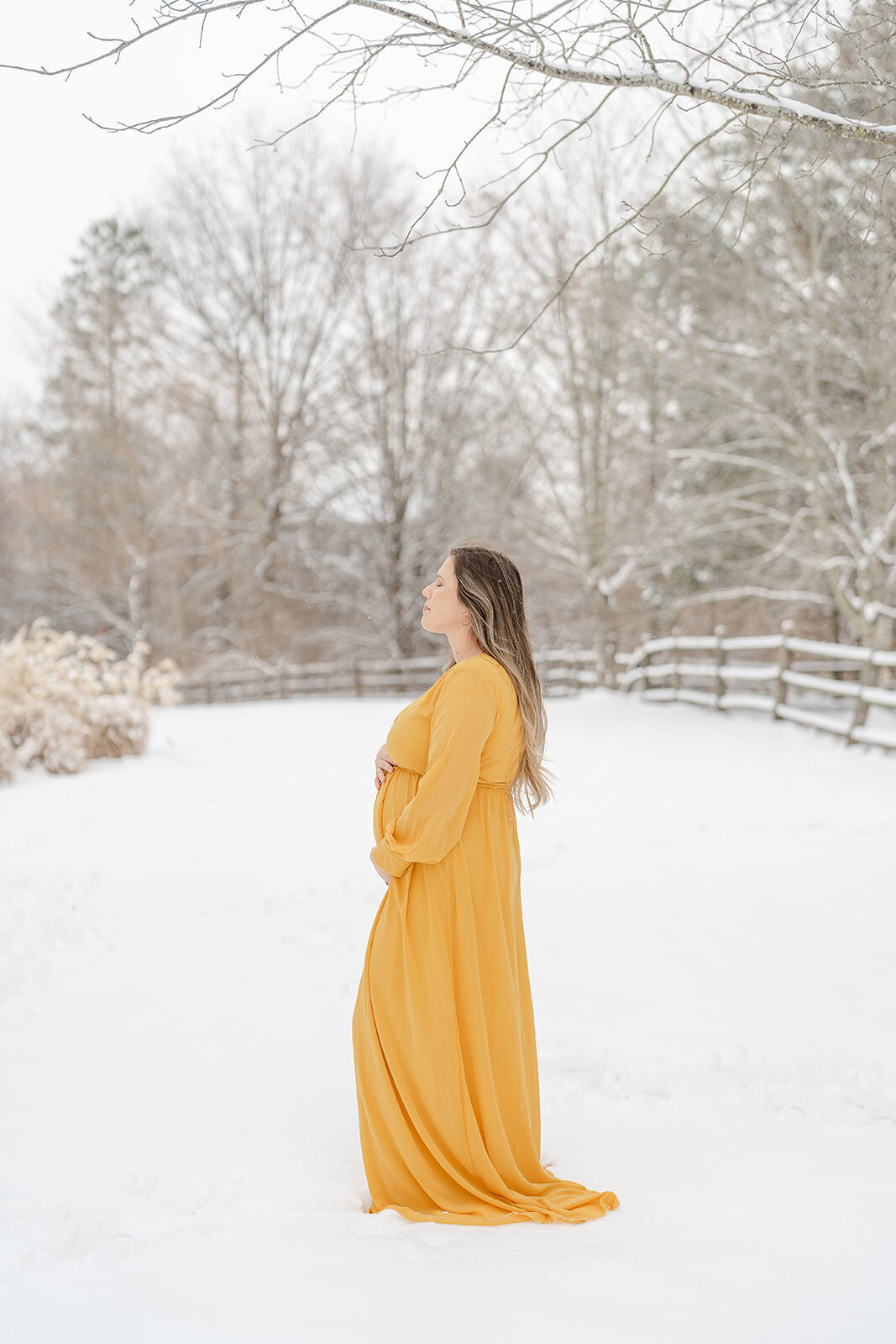 mom soaking in the moment during winter maternity photo in Manassas, Virginia
