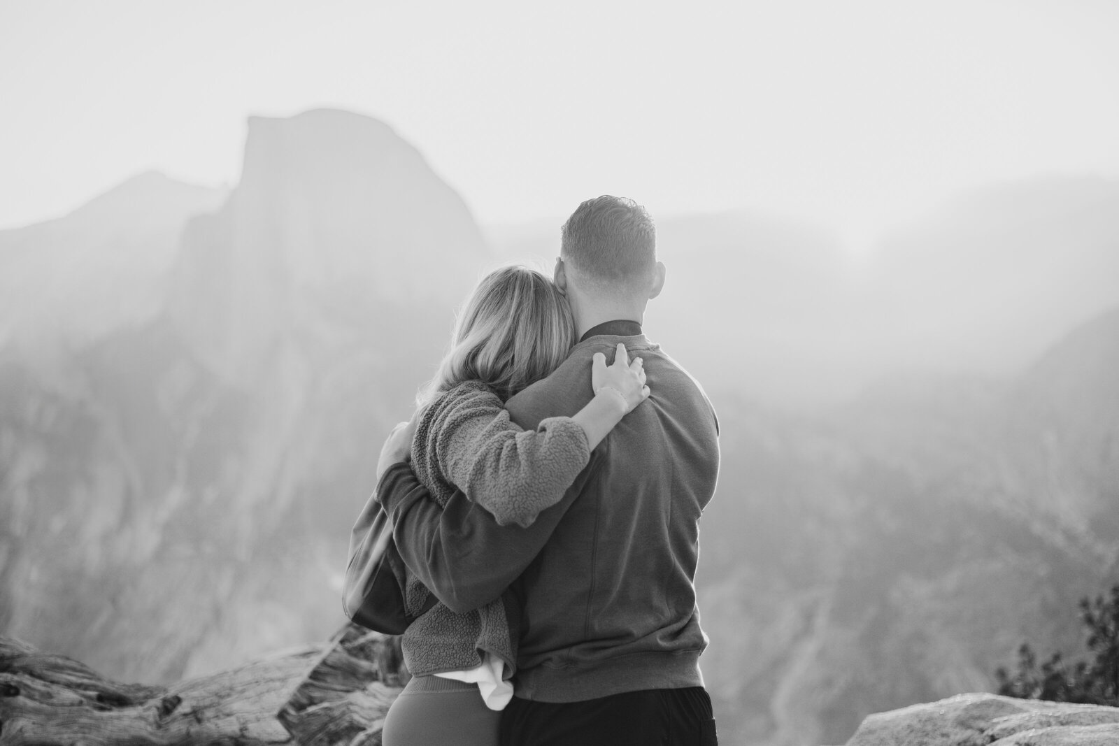 A wedding proposal between two hikers at sunrise in front of Half Dome in Yosemite National Park.