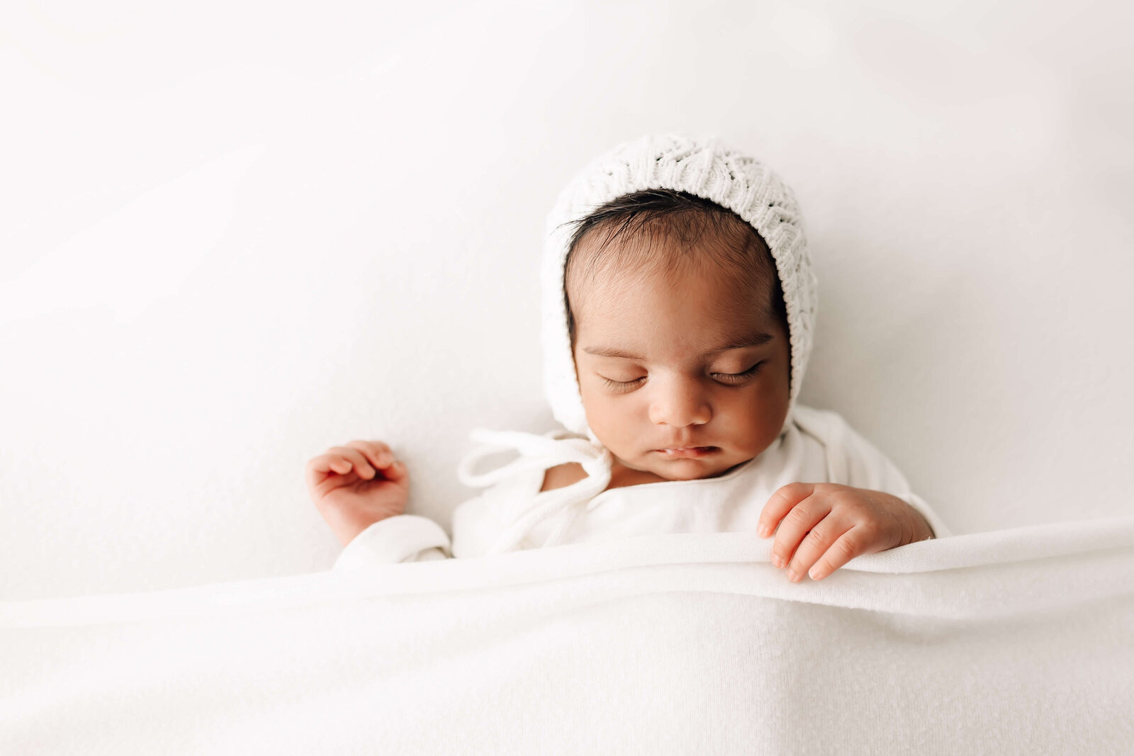 Baby in white bonnet