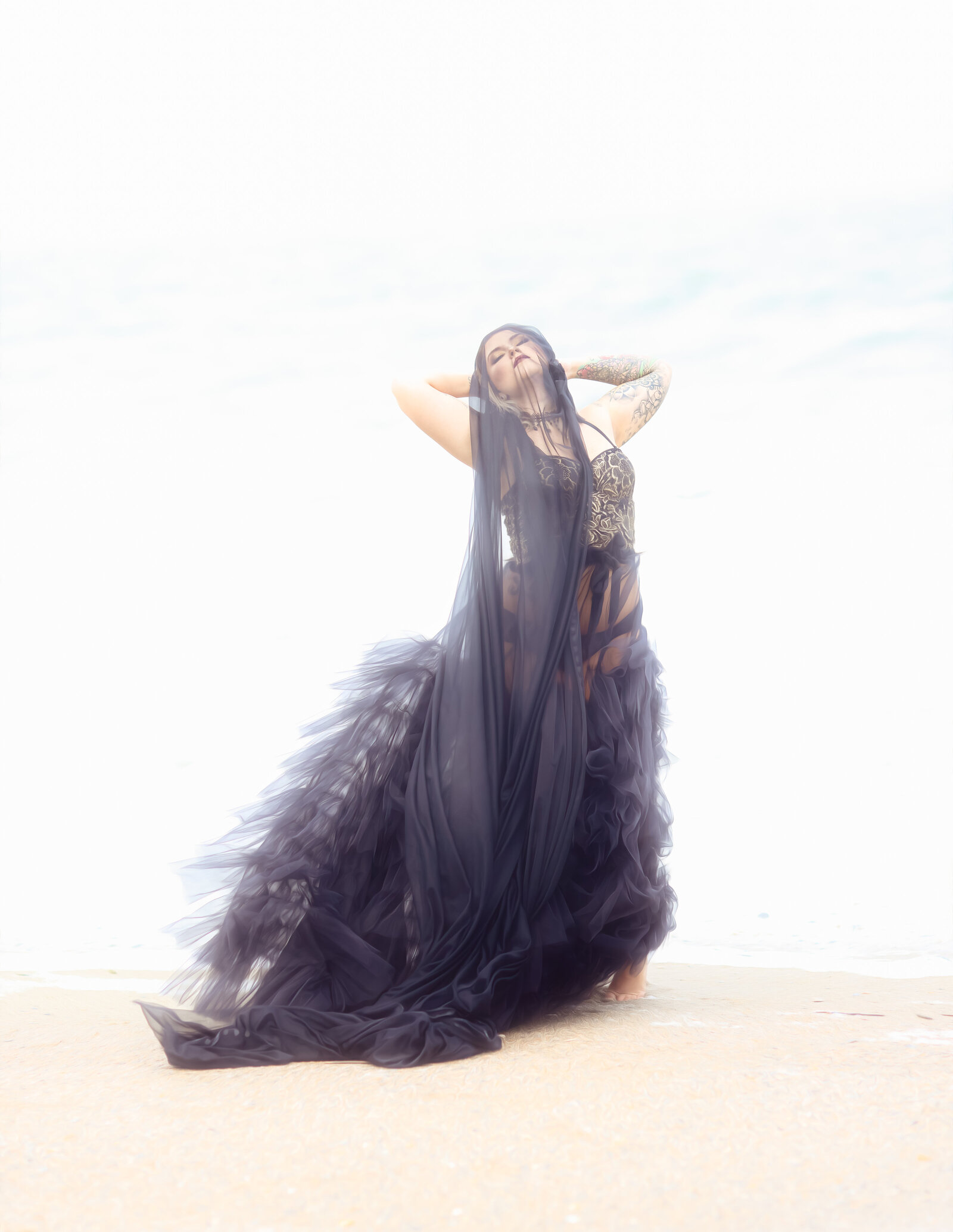 shot of woman on beach with black gown and veil (4)