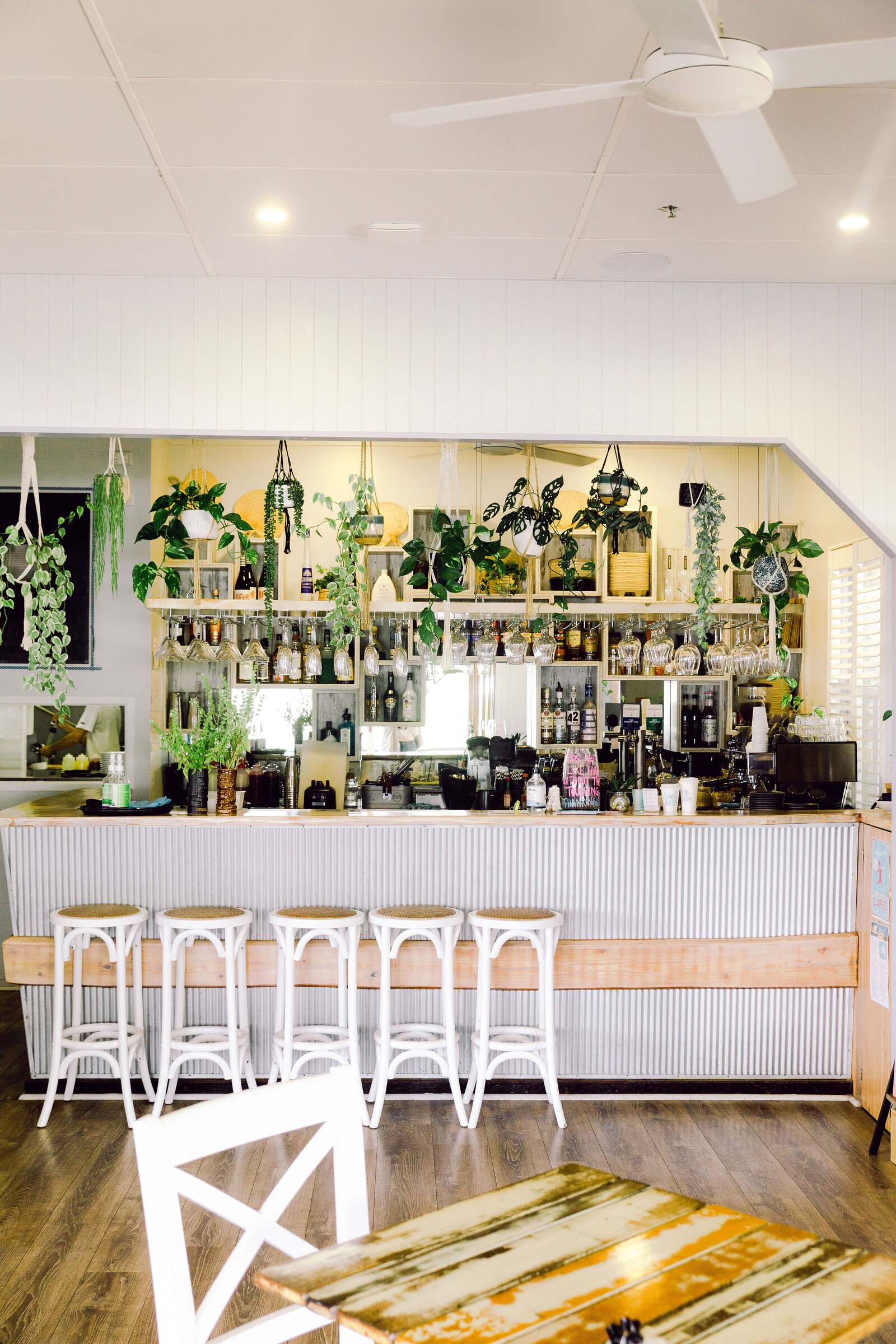 Modern meets industrial cafe with lots of plants