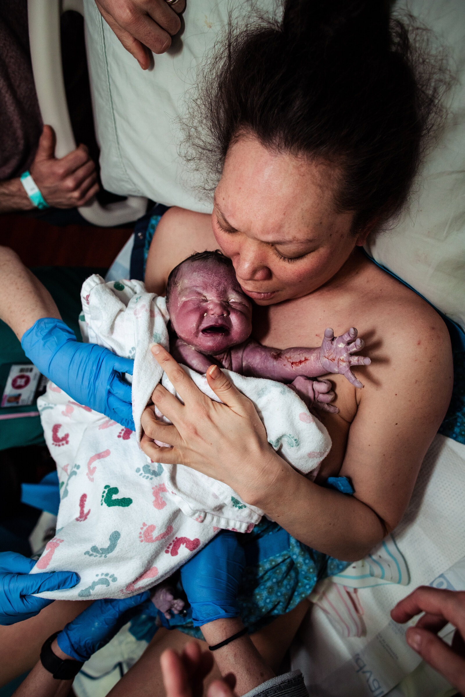 mom holding baby after birth