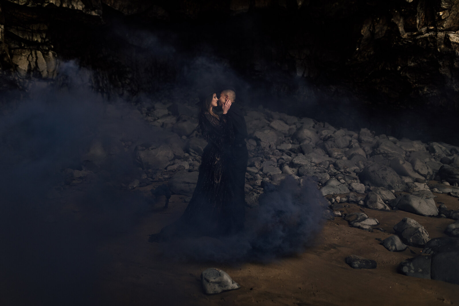 Bride in a black dress standing in dramatic foggy scenery, showcasing styled shoots for adventurous photographers in the Pacific Northwest.