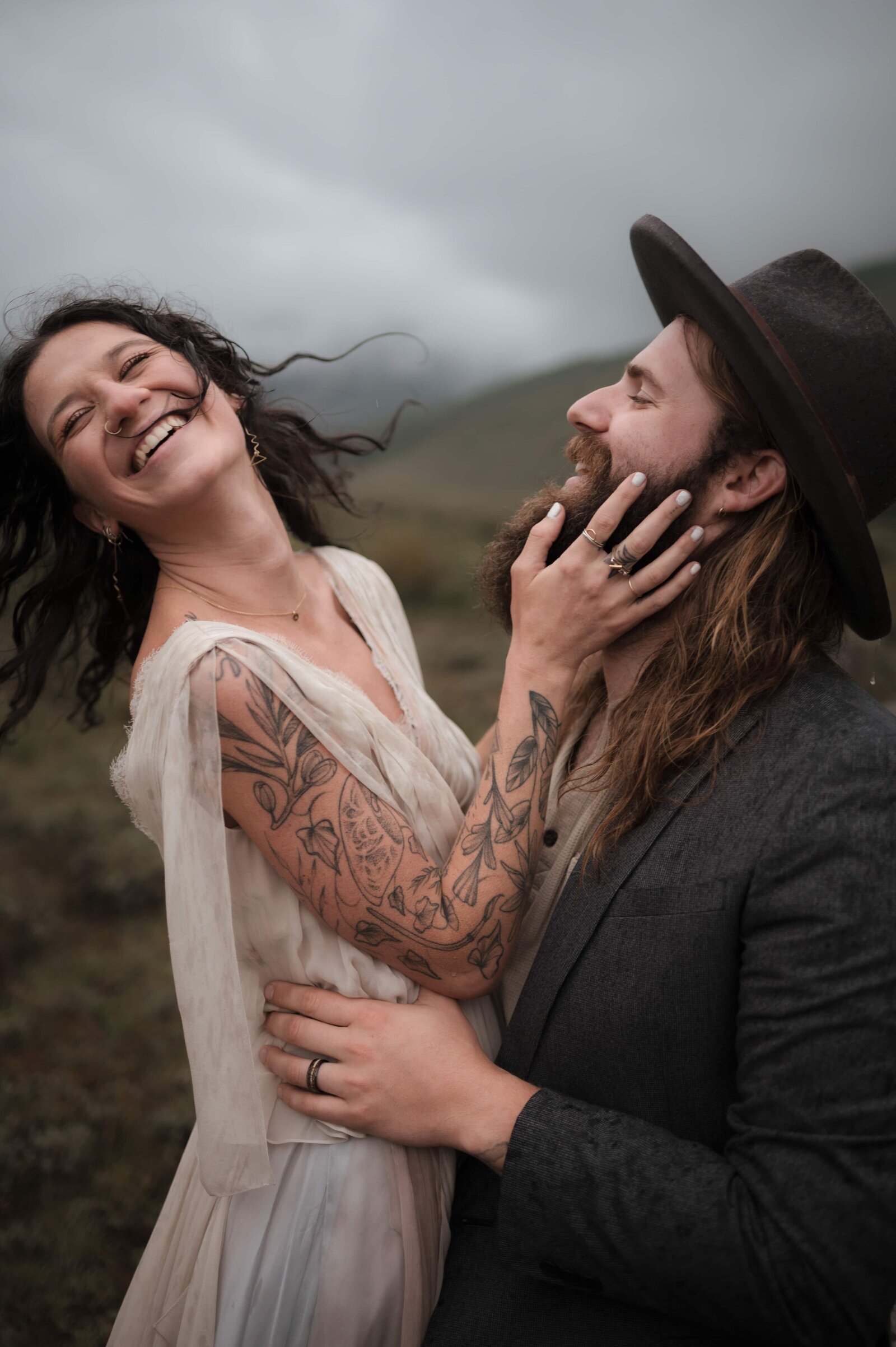 Couple eloping in the Scottish Highlands with rolling hills and mist and fog

