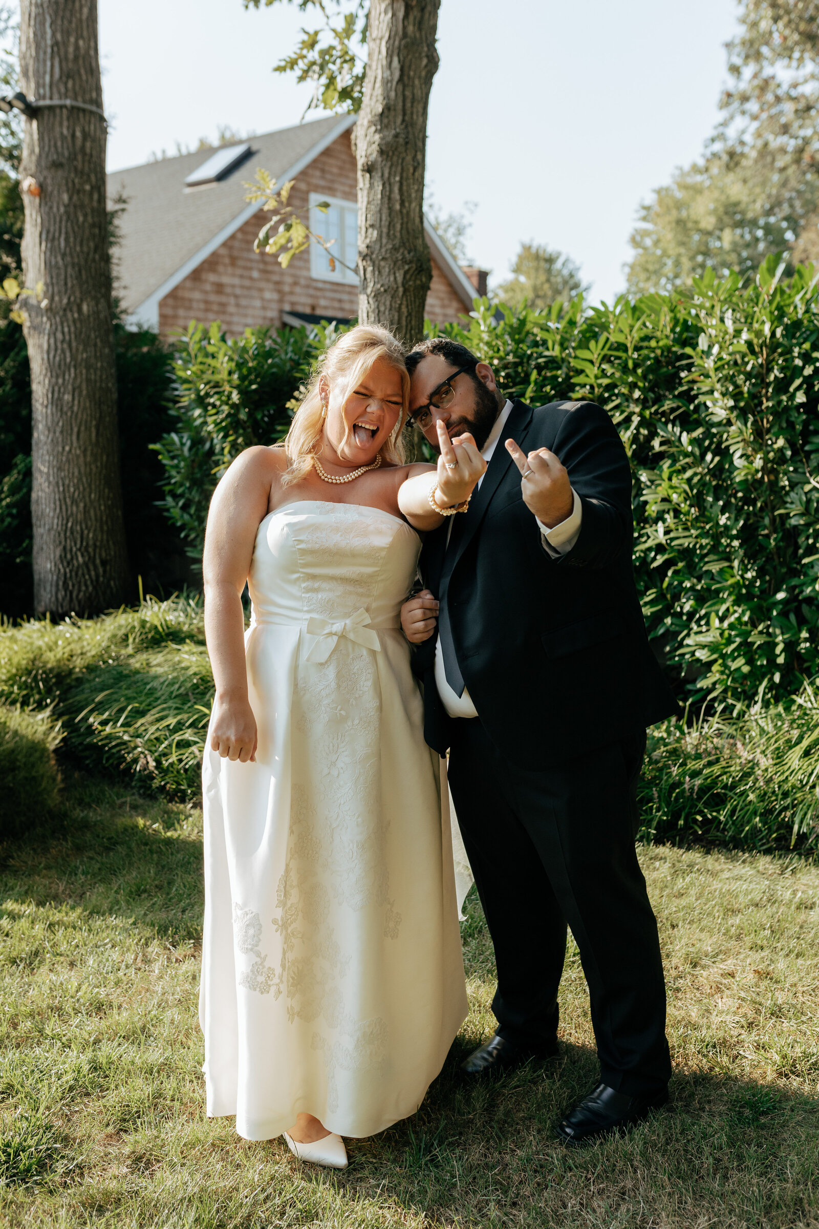 Newlywed couple showing off their wedding bands in a fun way at their outdoor wedding in Long Island | Emma LeeAnn Photography