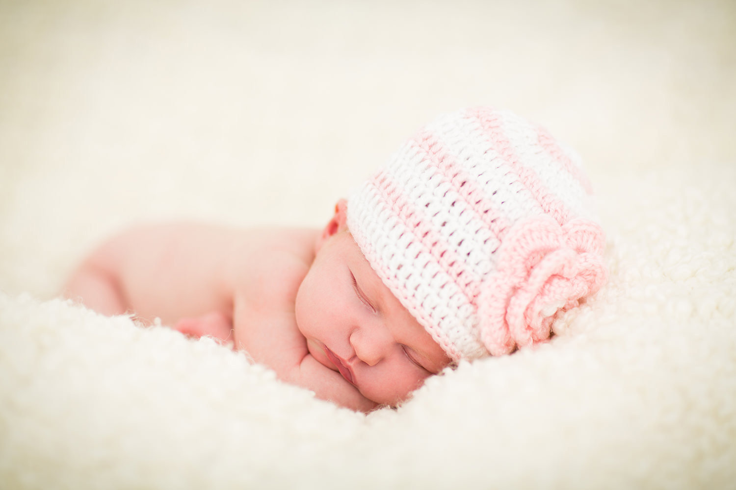 san diego newborn photography | newborn girl with pink and white crocheted hat sleeping