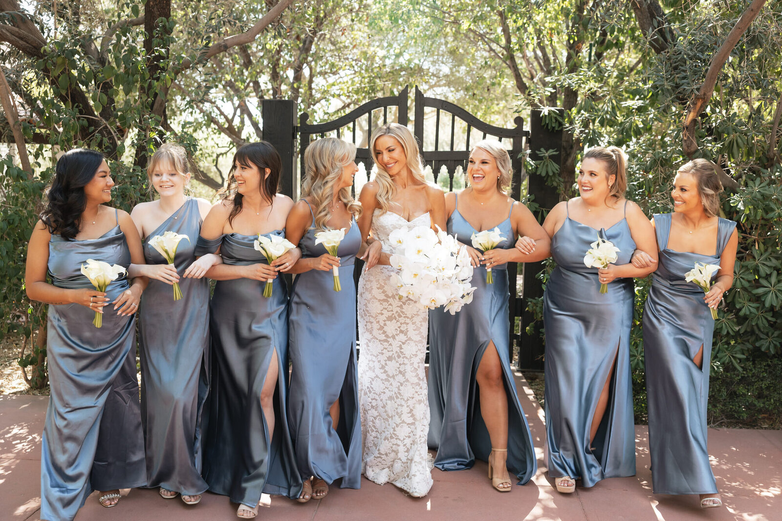 Bride and bridesmaids at El Chorro smiling at each other taken by Arizona wedding photographer