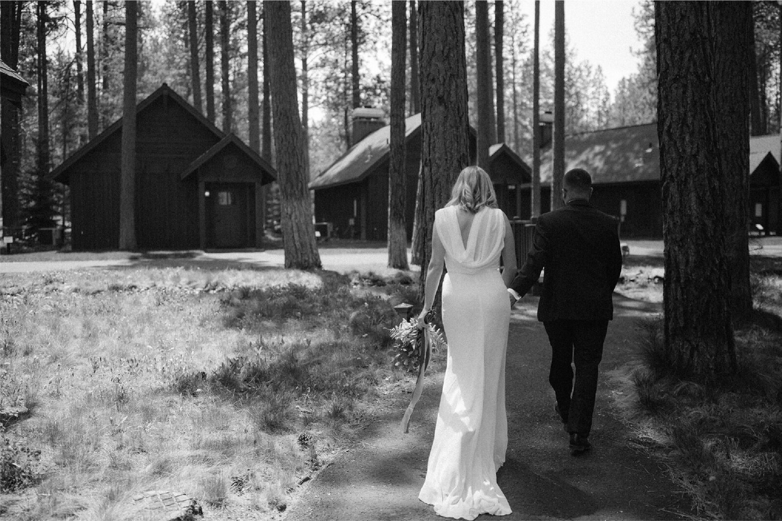 bride-and-groom-walking-hand-in-hand-by-cabins