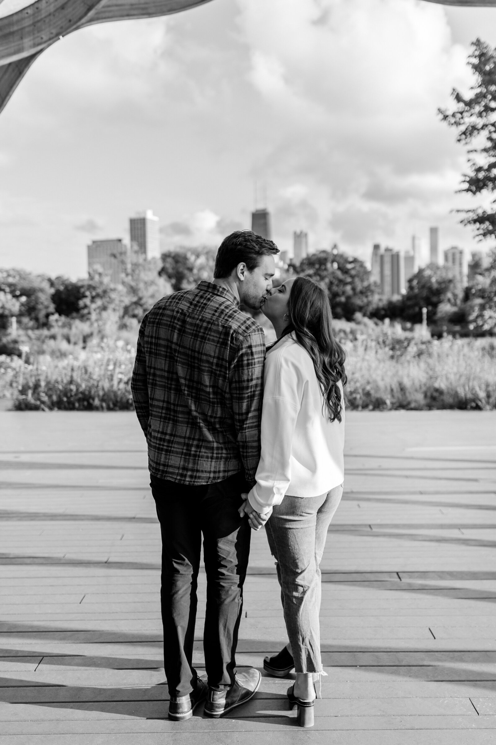 Engaged couple kissing under the honeycomb sculpture in Chicago